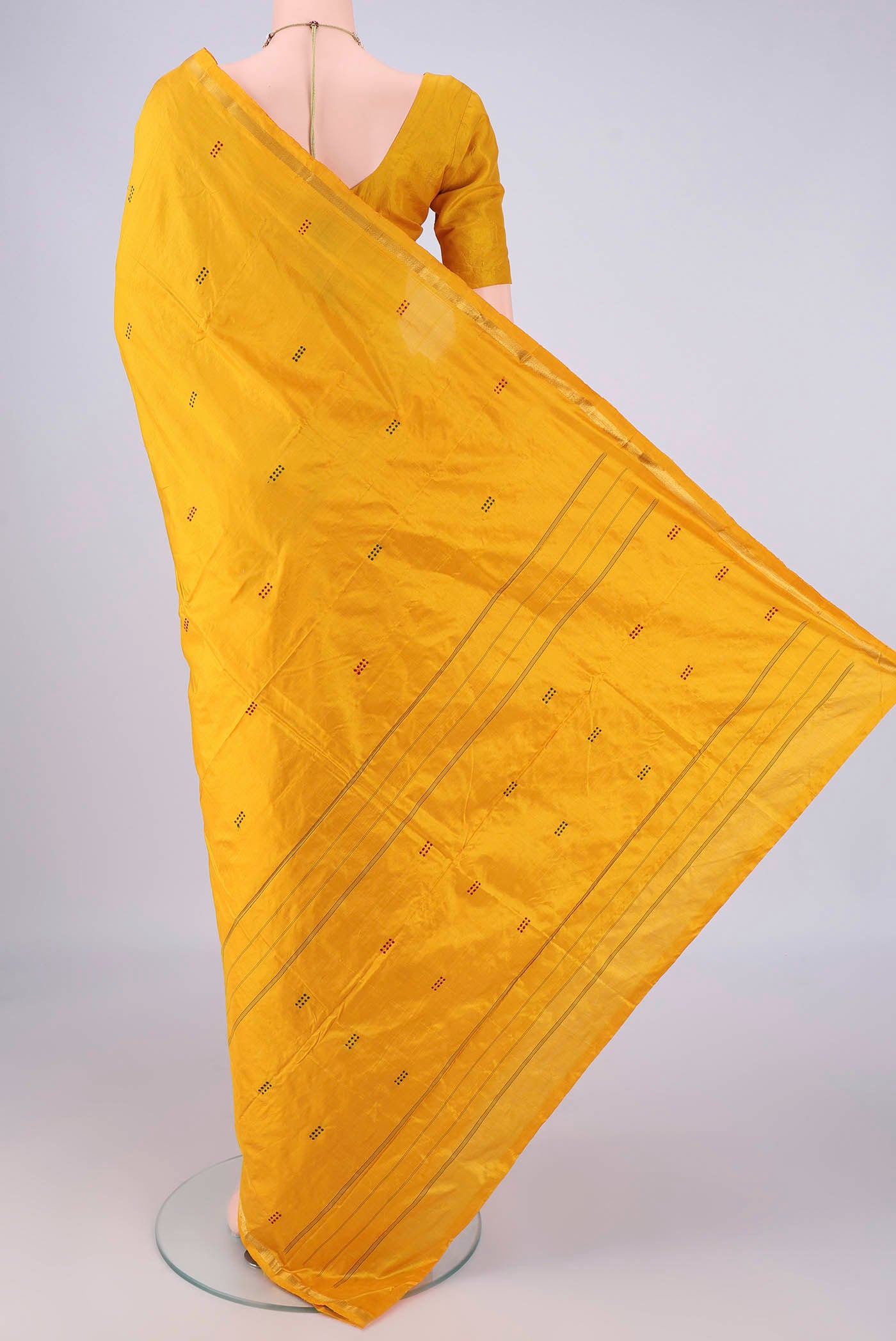 Flat view of Yellow Kanchipuram Silk Saree with Thread Butta on the body and Zari Border. 