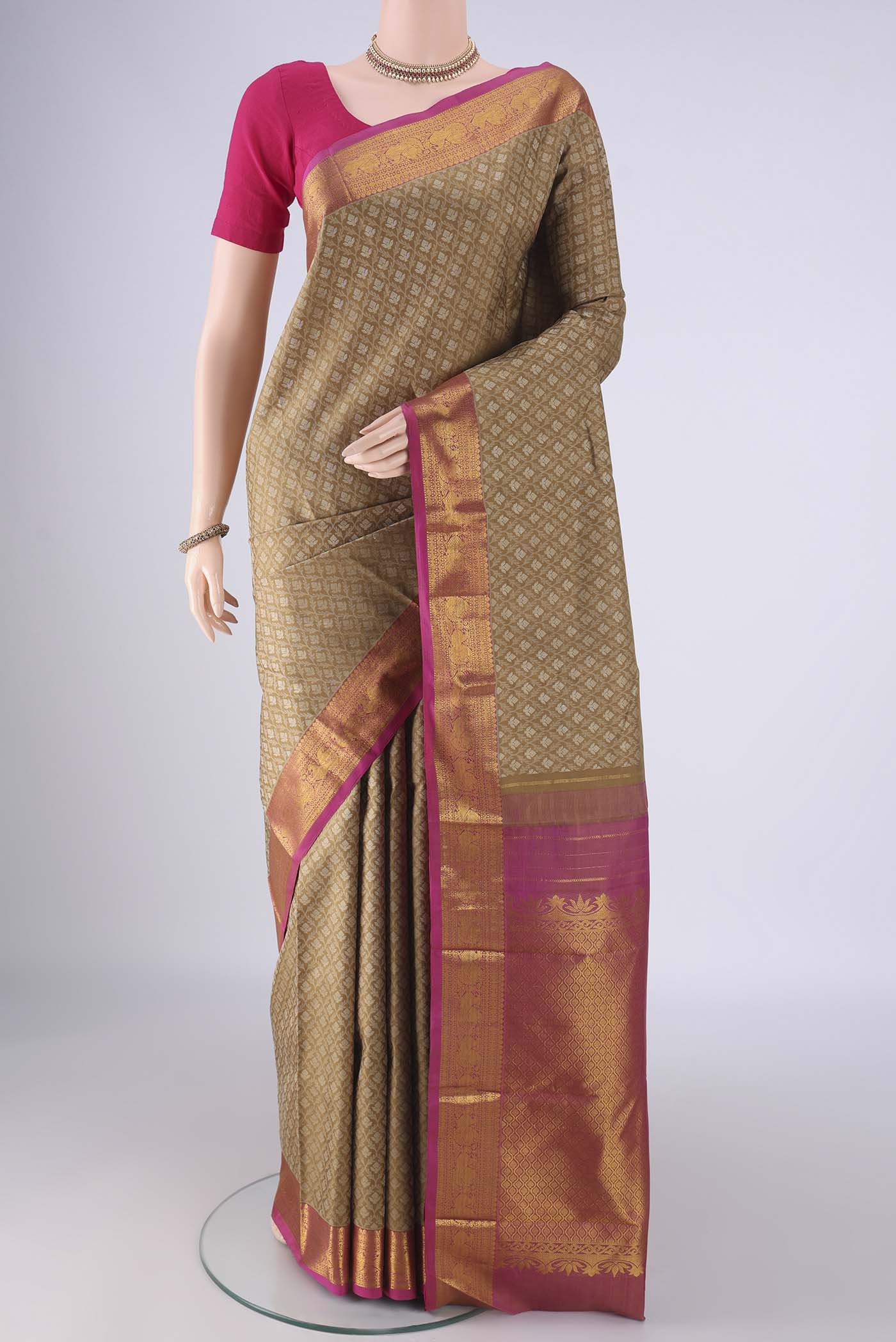 Brown Kanjivaram Silk Saree with Jacquard With Zari Butta on the body and Zari Border.  displayed on a mannequin