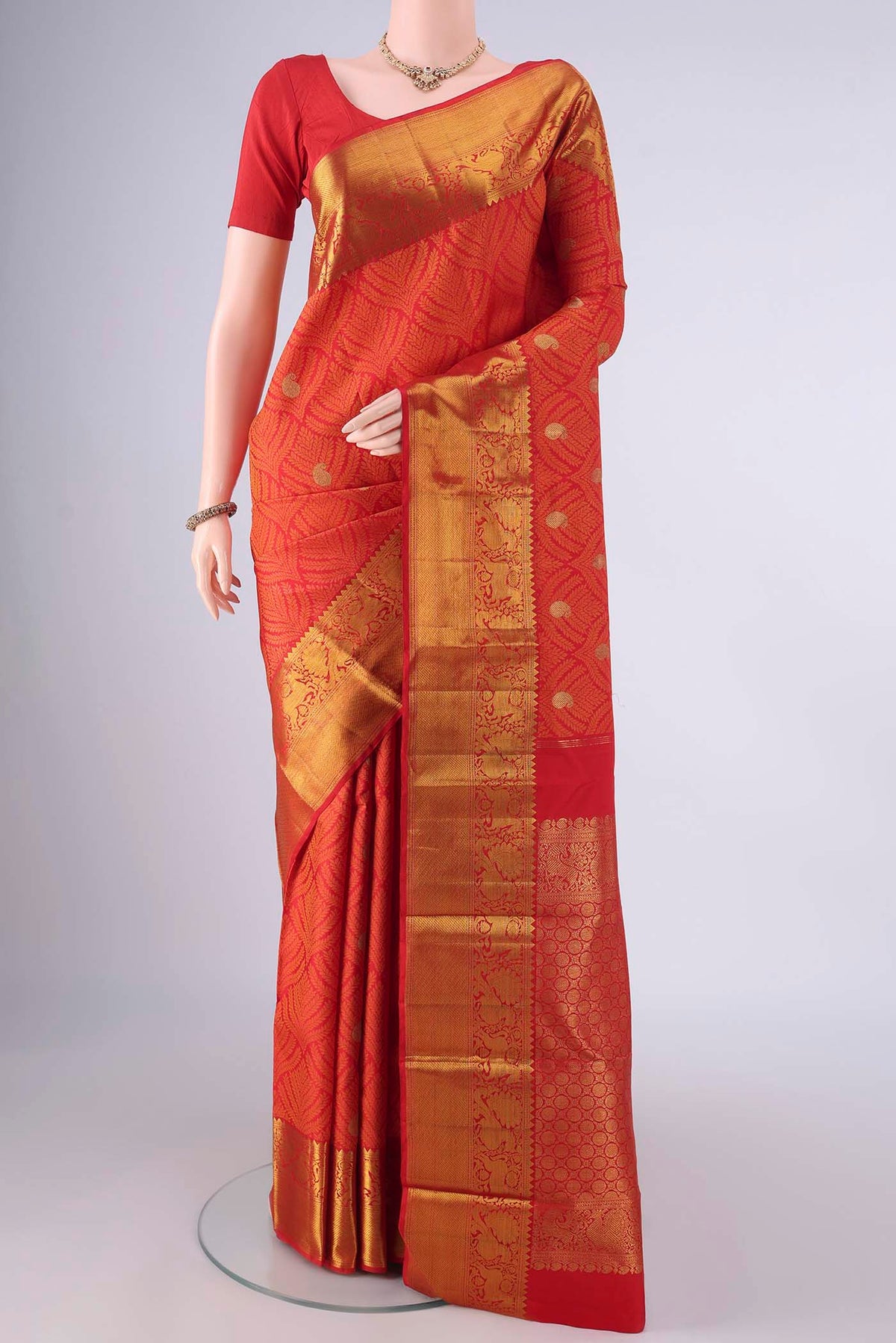 Pure Silk Red Kanjivaram Saree with Jacquard With Zari Butta on the body and Zari Border.  displayed on a mannequin