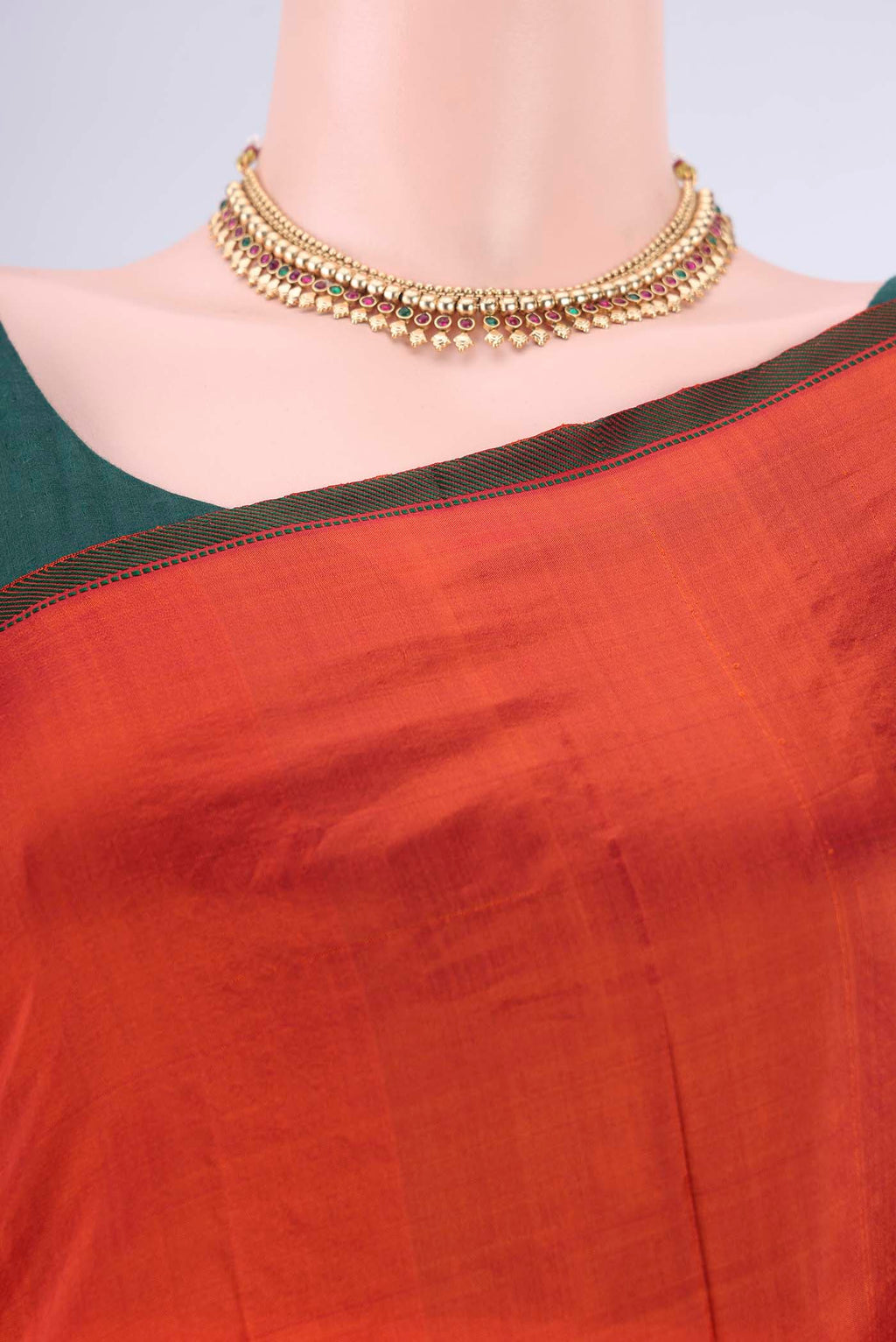 Border image of Orange Kanchipuram Silk Saree with Plain Body and Thread Border. 
