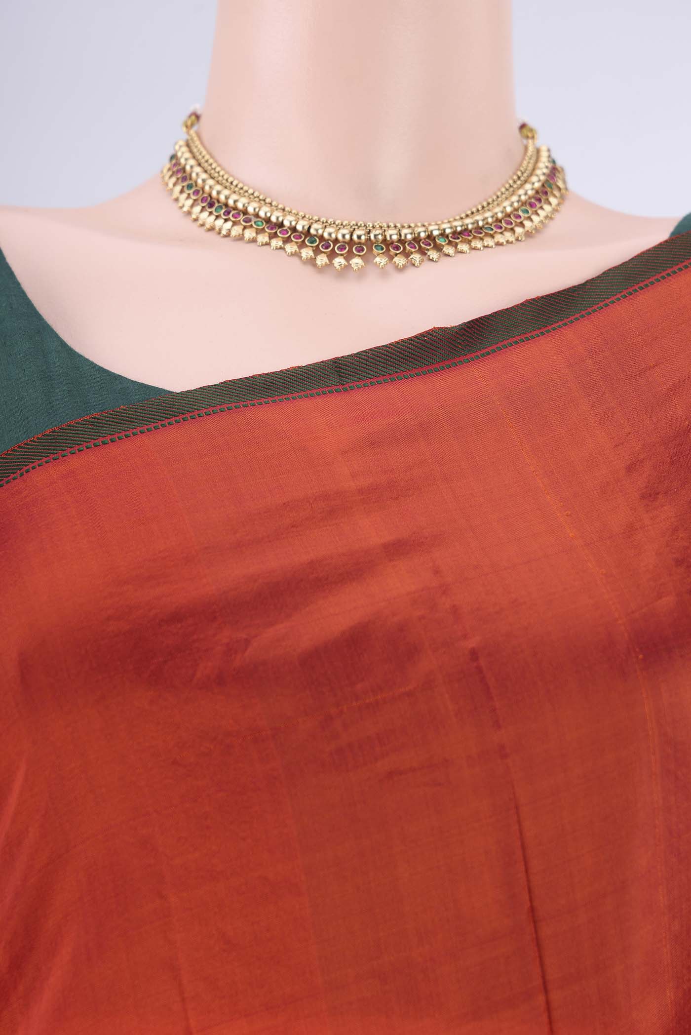 Border image of Orange Kanchipuram Silk Saree with Plain Body and Thread Border. 