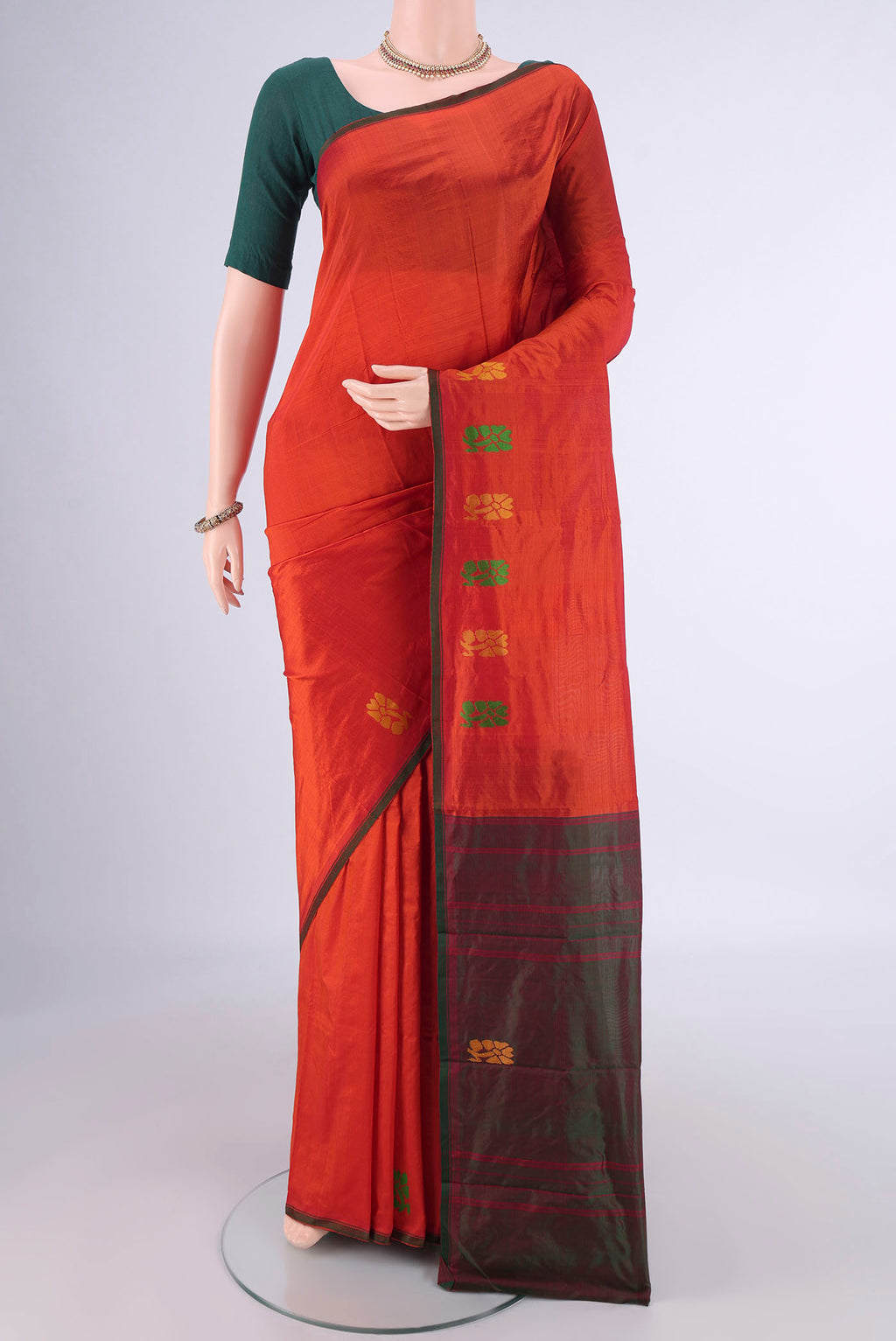 Orange Kanchipuram Silk Saree with Plain Body and Thread Border.  displayed on a mannequin