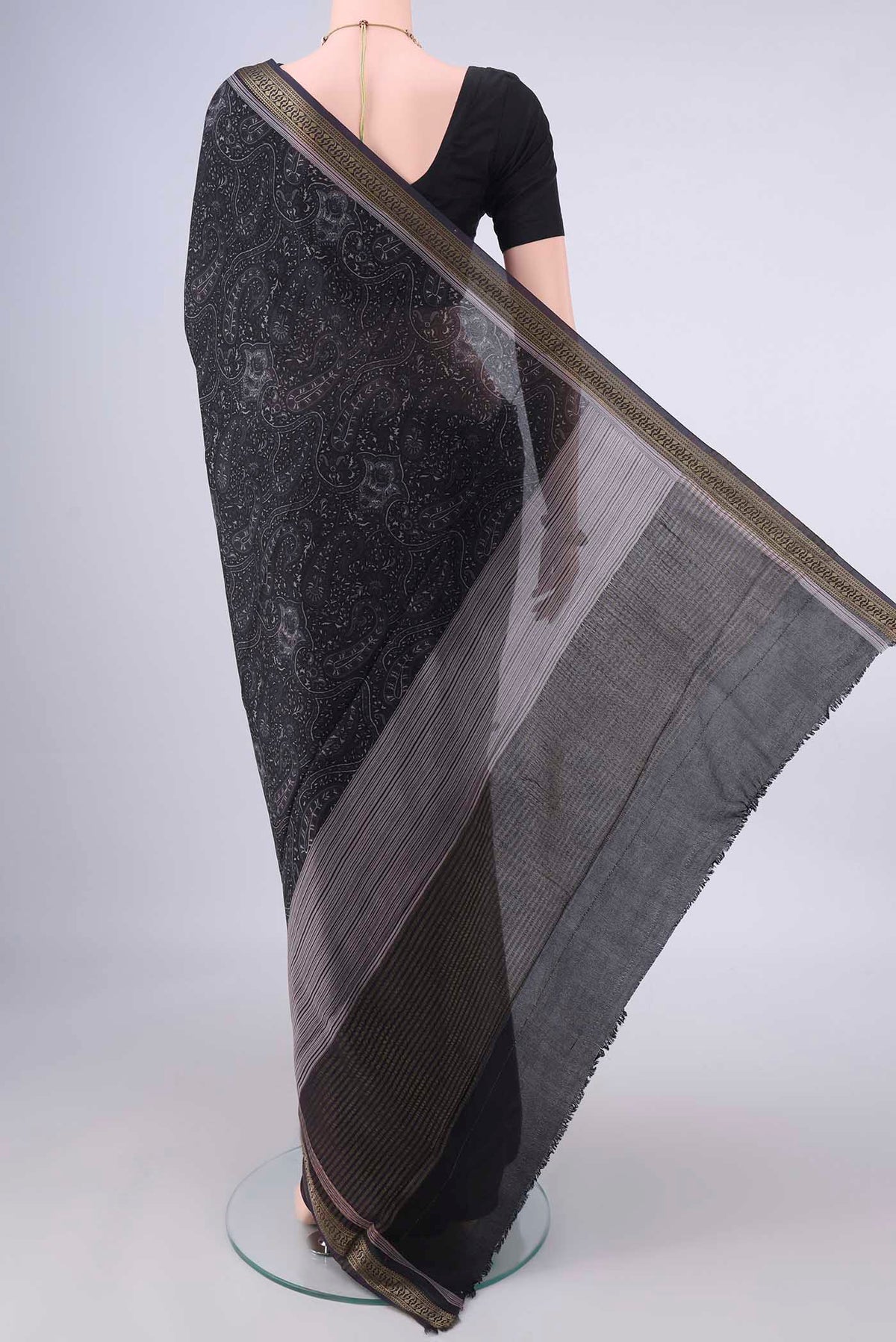 Flat view of Black Mysore Crepe Saree with Printed design on the body and Zari Border. 