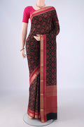 Black Crepe Saree with Floral Print on the body and Zari Border.  displayed on a mannequin