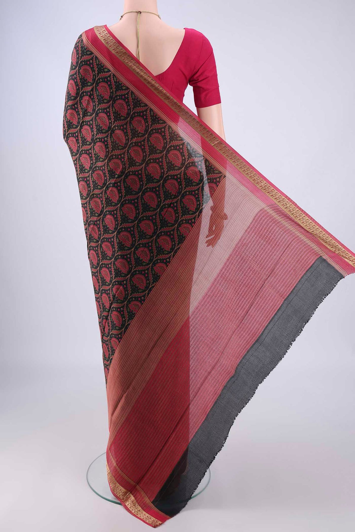 Flat view of Black Crepe Saree with Floral Print on the body and Zari Border. 