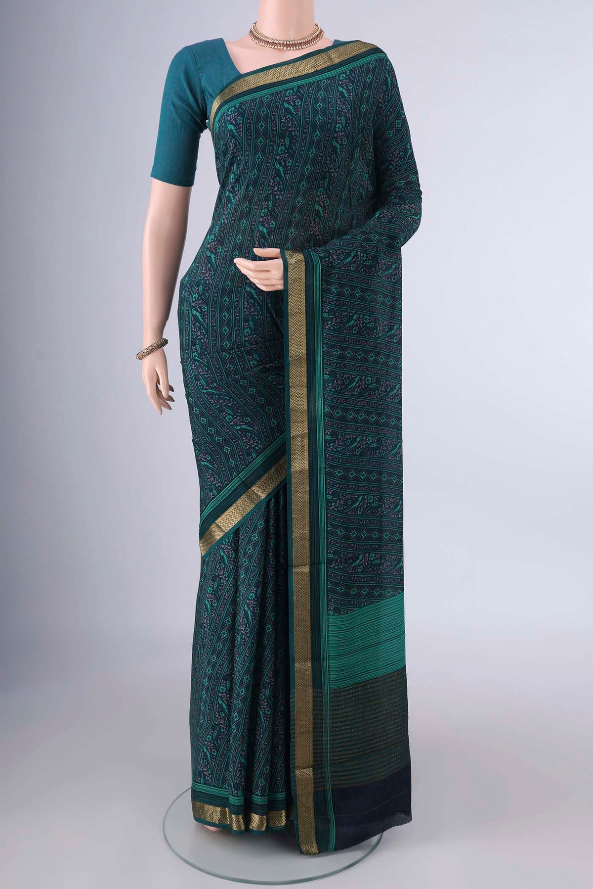 Navy Blue Mysore Crepe Saree with Plain Body and Zari Border.  displayed on a mannequin