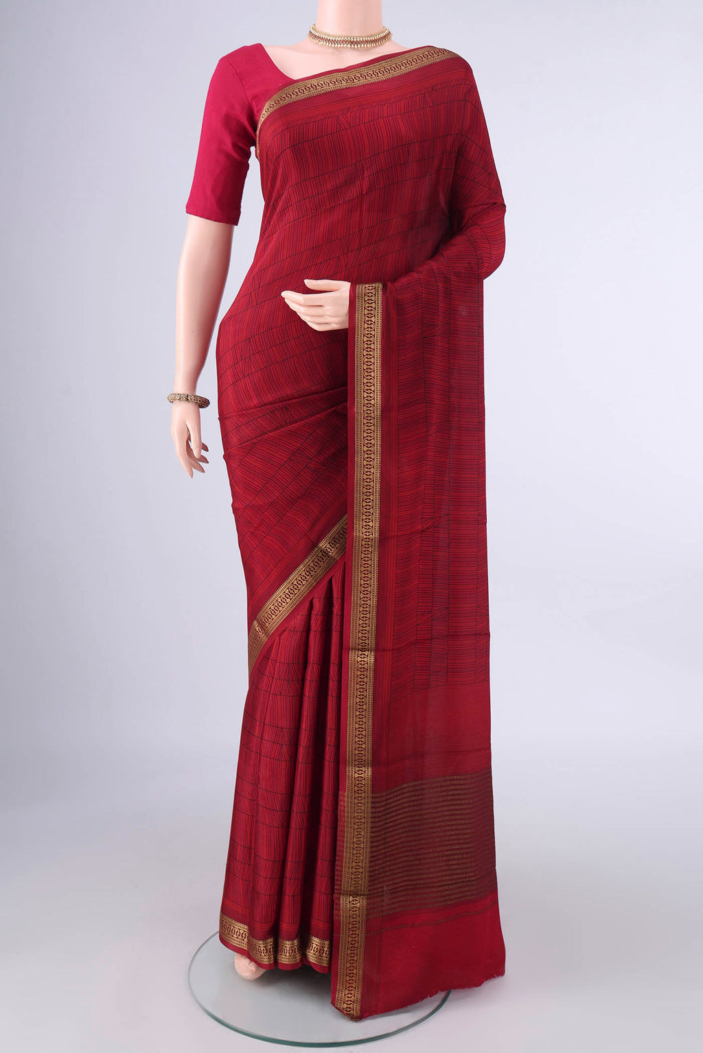 Red Mysore Crepe Saree with Printed design on the body and Zari Border.  displayed on a mannequin
