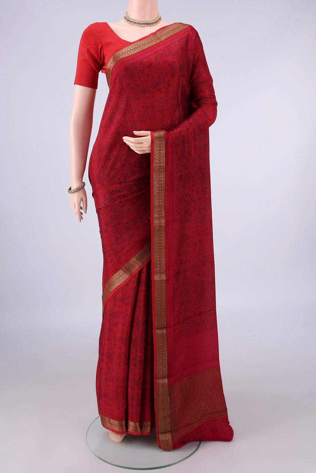 Red Mysore Crepe Saree with Printed design on the body and Zari Border.  displayed on a mannequin