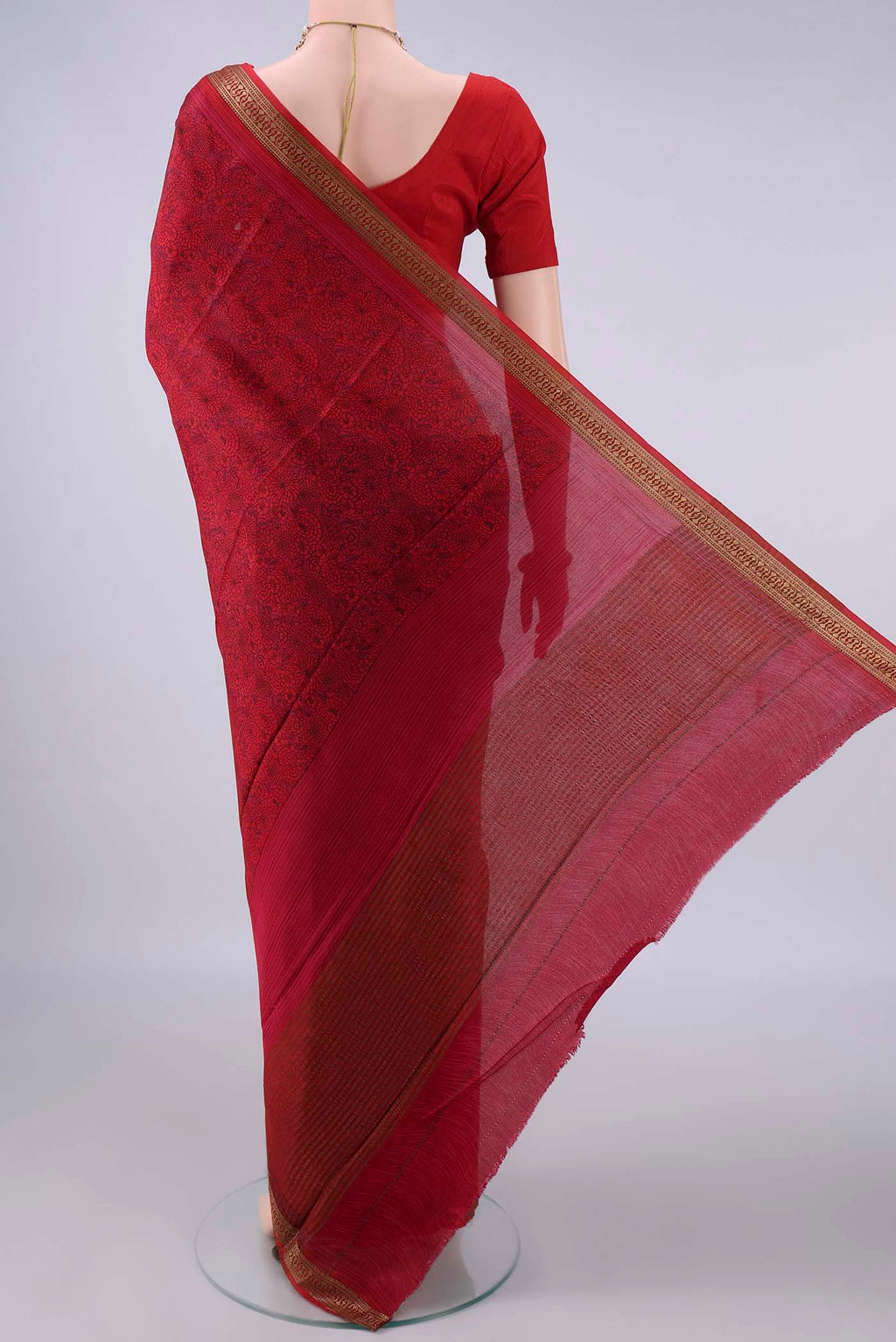 Flat view of Red Mysore Crepe Saree with Printed design on the body and Zari Border. 