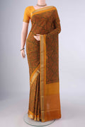 Mustard Mysore Crepe Saree with Printed design on the body and Zari Border.  displayed on a mannequin