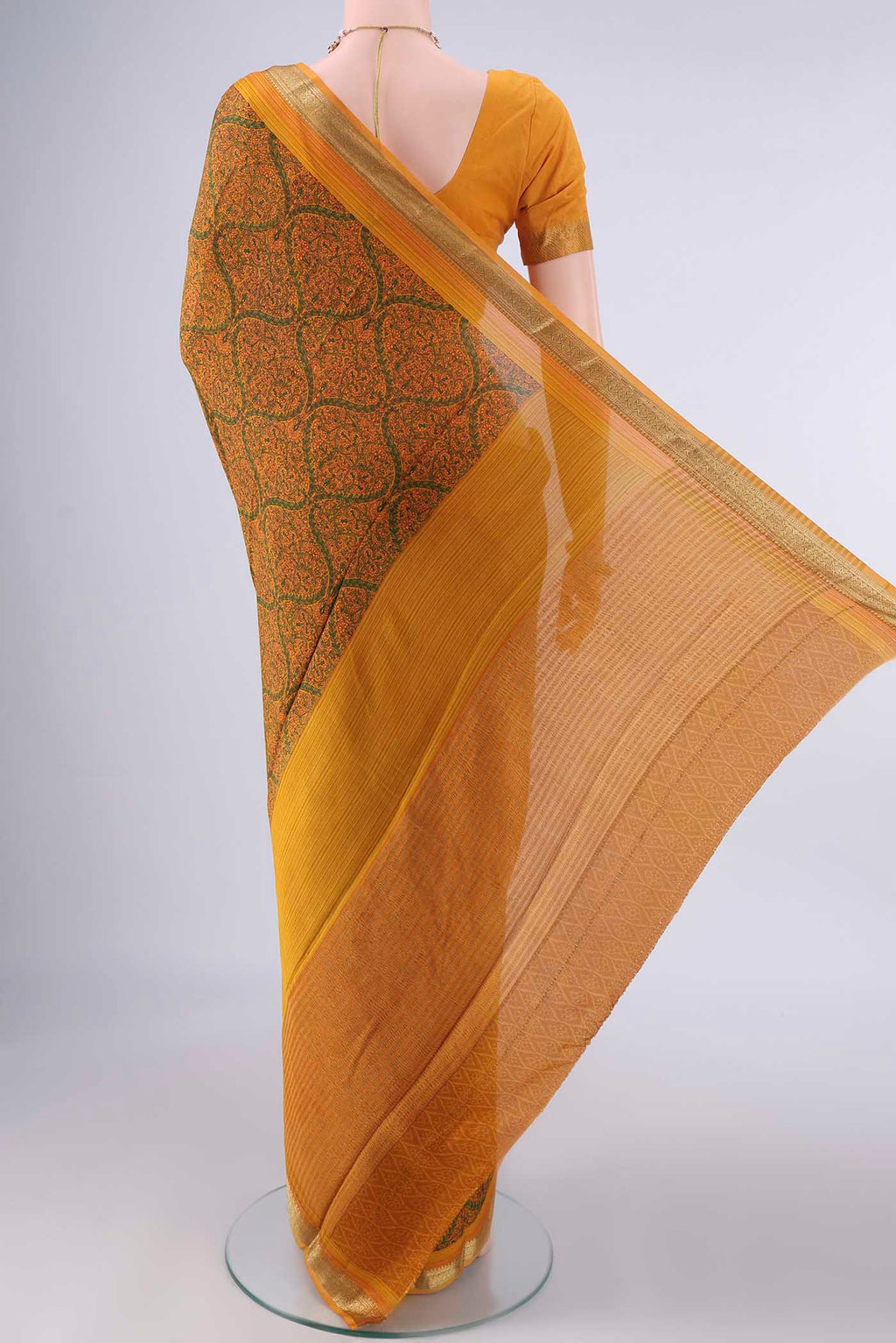 Flat view of Mustard Mysore Crepe Saree with Printed design on the body and Zari Border. 