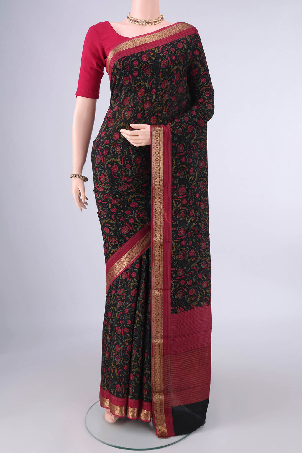 Black Mysore Crepe Saree with Printed design on the body and Zari Border.  displayed on a mannequin