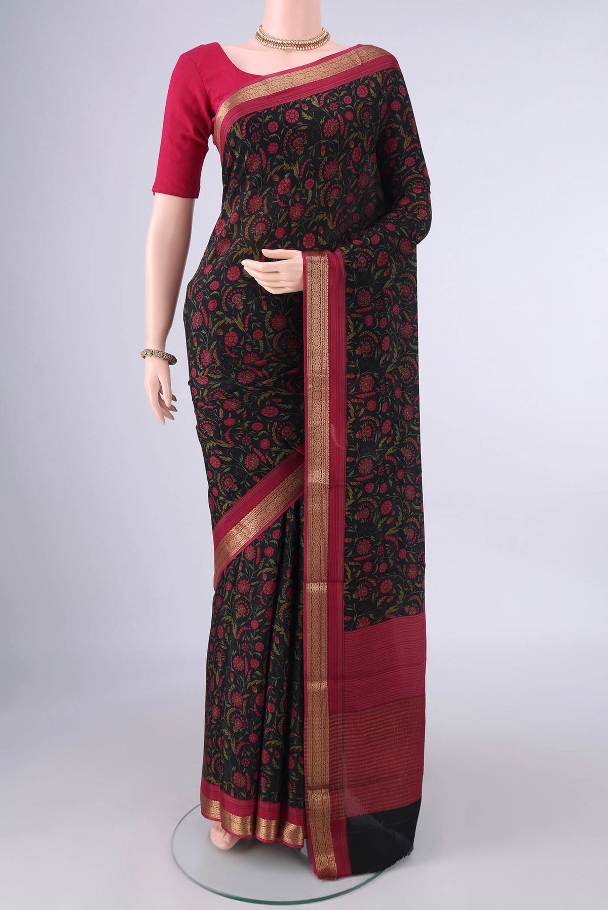 Black Mysore Crepe Saree with Printed design on the body and Zari Border.  displayed on a mannequin