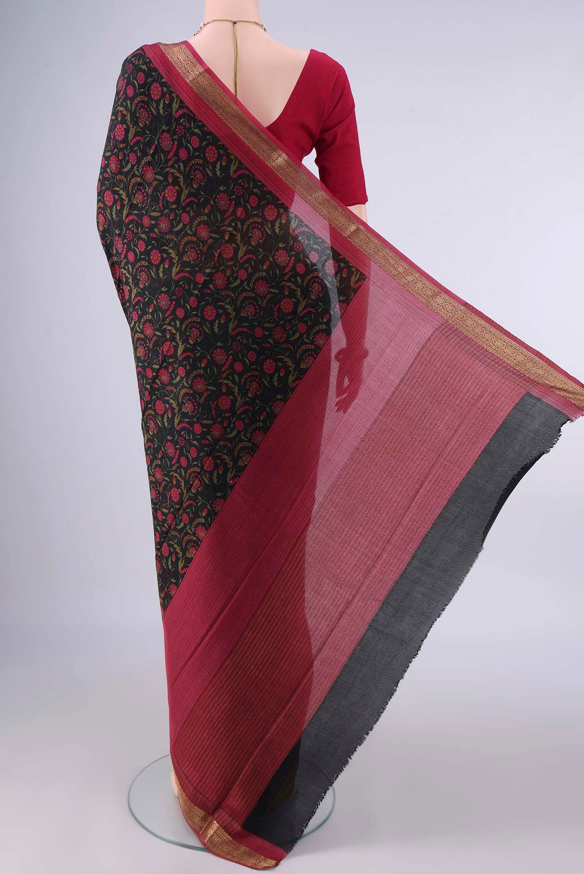 Flat view of Black Mysore Crepe Saree with Printed design on the body and Zari Border. 