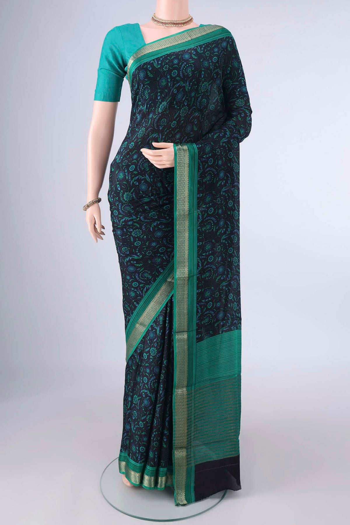 Black Mysore Crepe Saree with Printed design on the body and Zari Border.  displayed on a mannequin