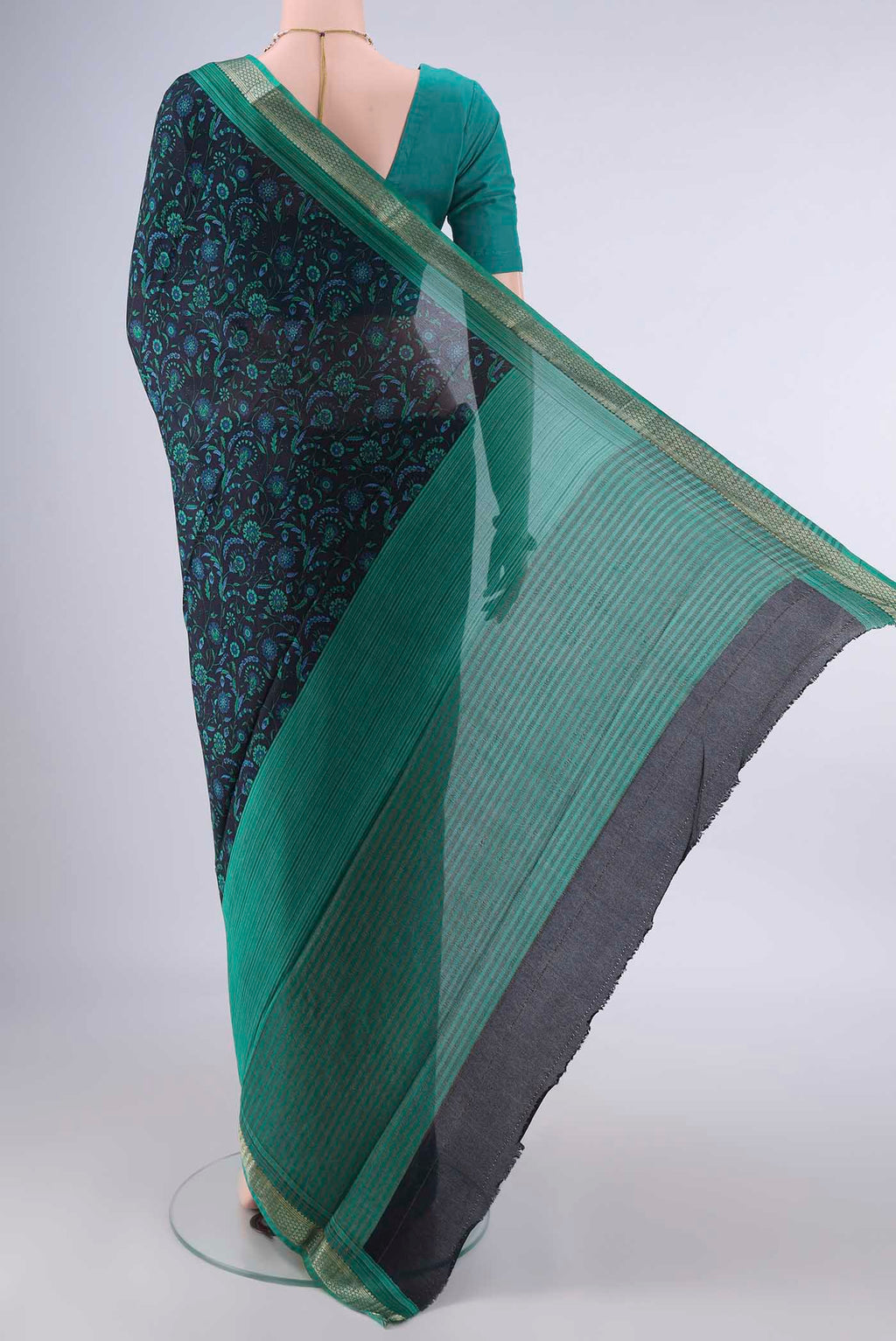 Flat view of Black Mysore Crepe Saree with Printed design on the body and Zari Border. 