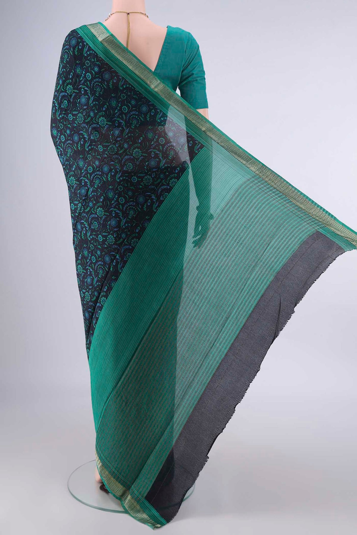 Flat view of Black Mysore Crepe Saree with Printed design on the body and Zari Border. 