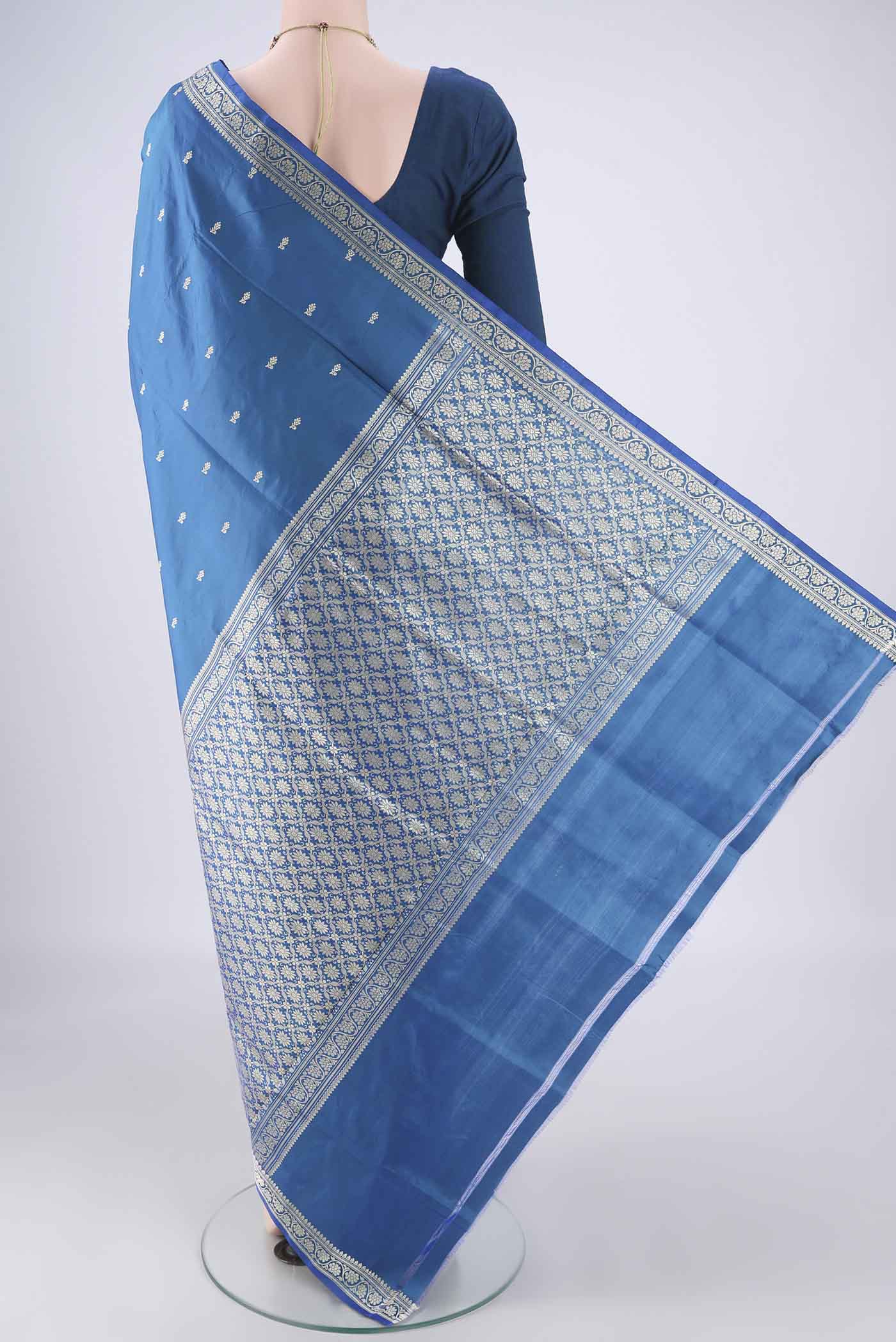 Flat view of Blue Dual Tone Banarasi Katan Silk Saree with Thread Butta on the body and Thread Border. 