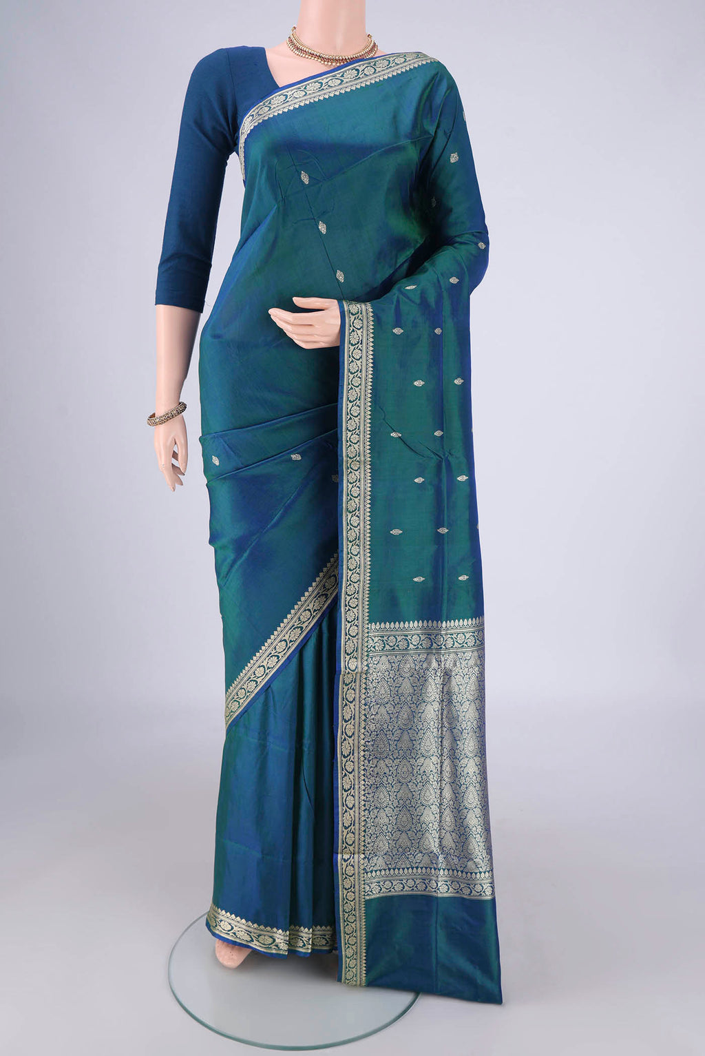 Peacock Blue Banarasi Silk Saree with Thread Butta on the body and Thread Border.  displayed on a mannequin