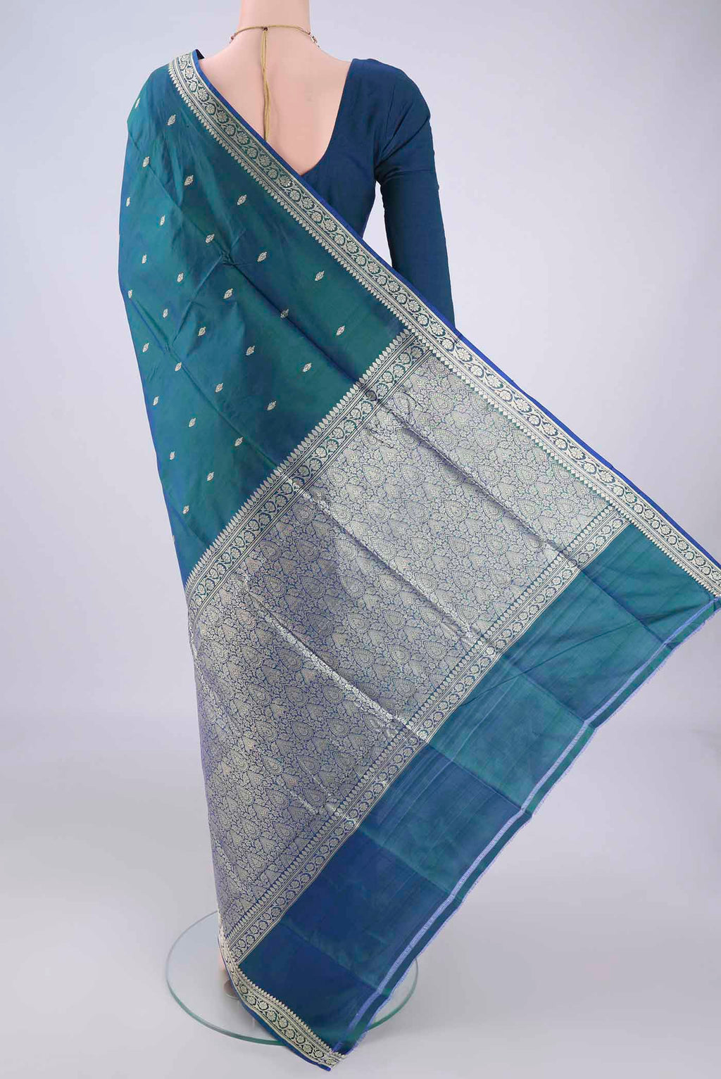 Flat view of Peacock Blue Banarasi Silk Saree with Thread Butta on the body and Thread Border. 