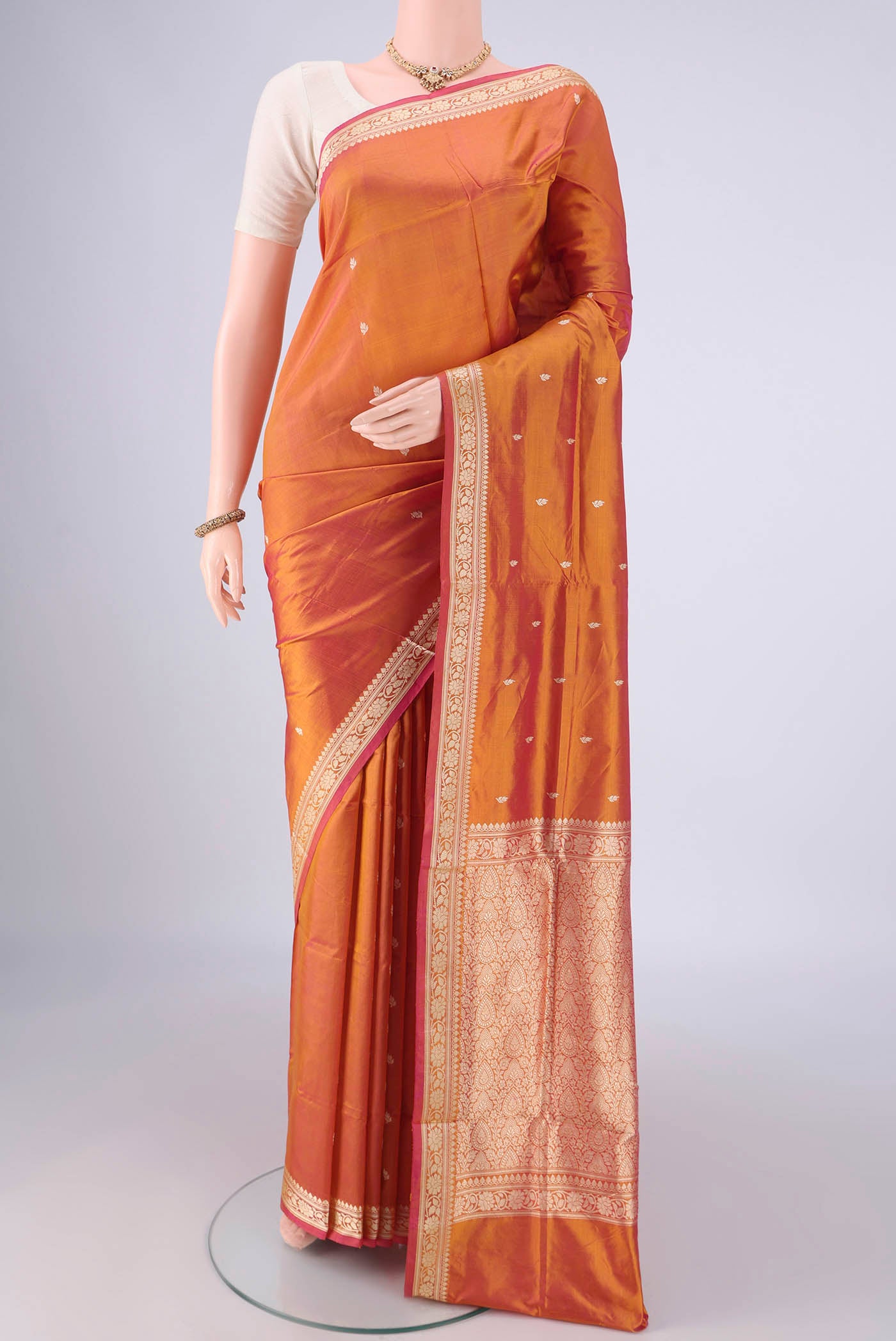 Rust Banarasi Silk Saree with Thread Butta on the body and Thread Border.  displayed on a mannequin