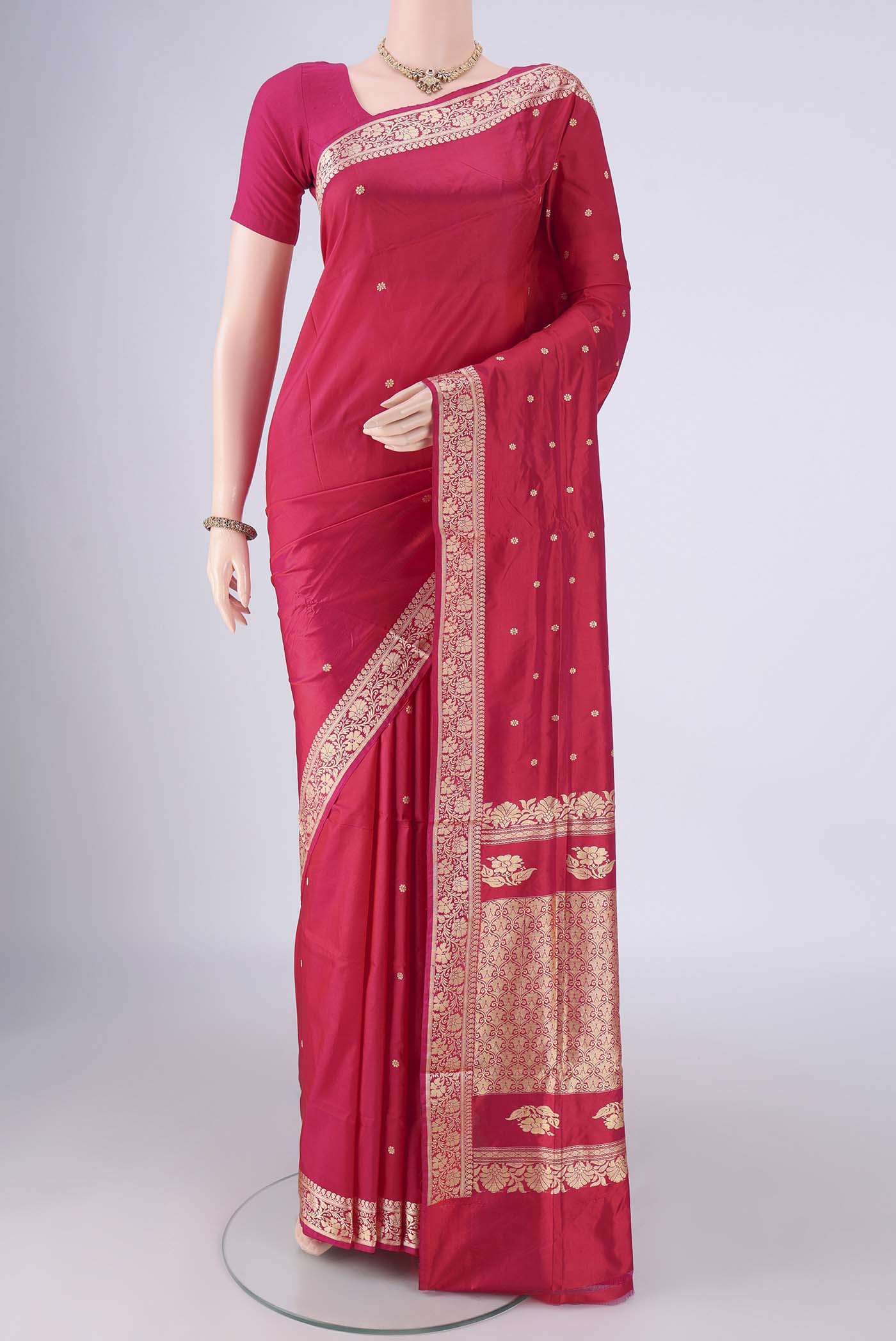 Dark Pink Banarasi Silk Saree with Thread Butta on the body and Thread Border.  displayed on a mannequin