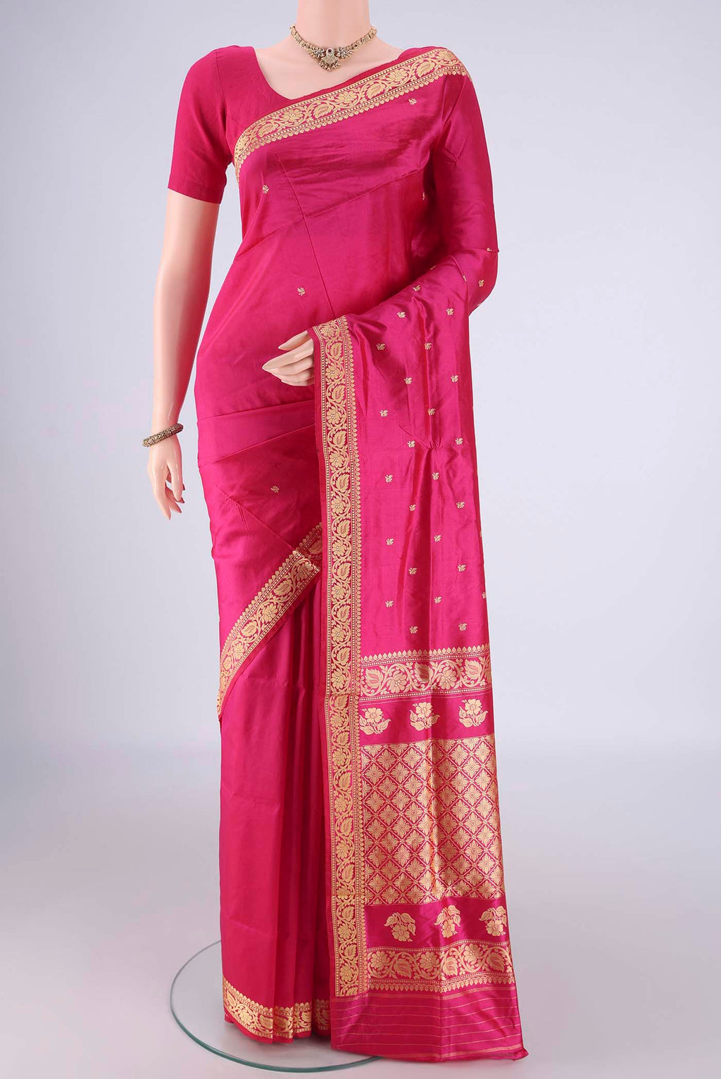 Rani Pink Banarasi Katan Silk Saree with Thread Butta on the body and Thread Border.  displayed on a mannequin