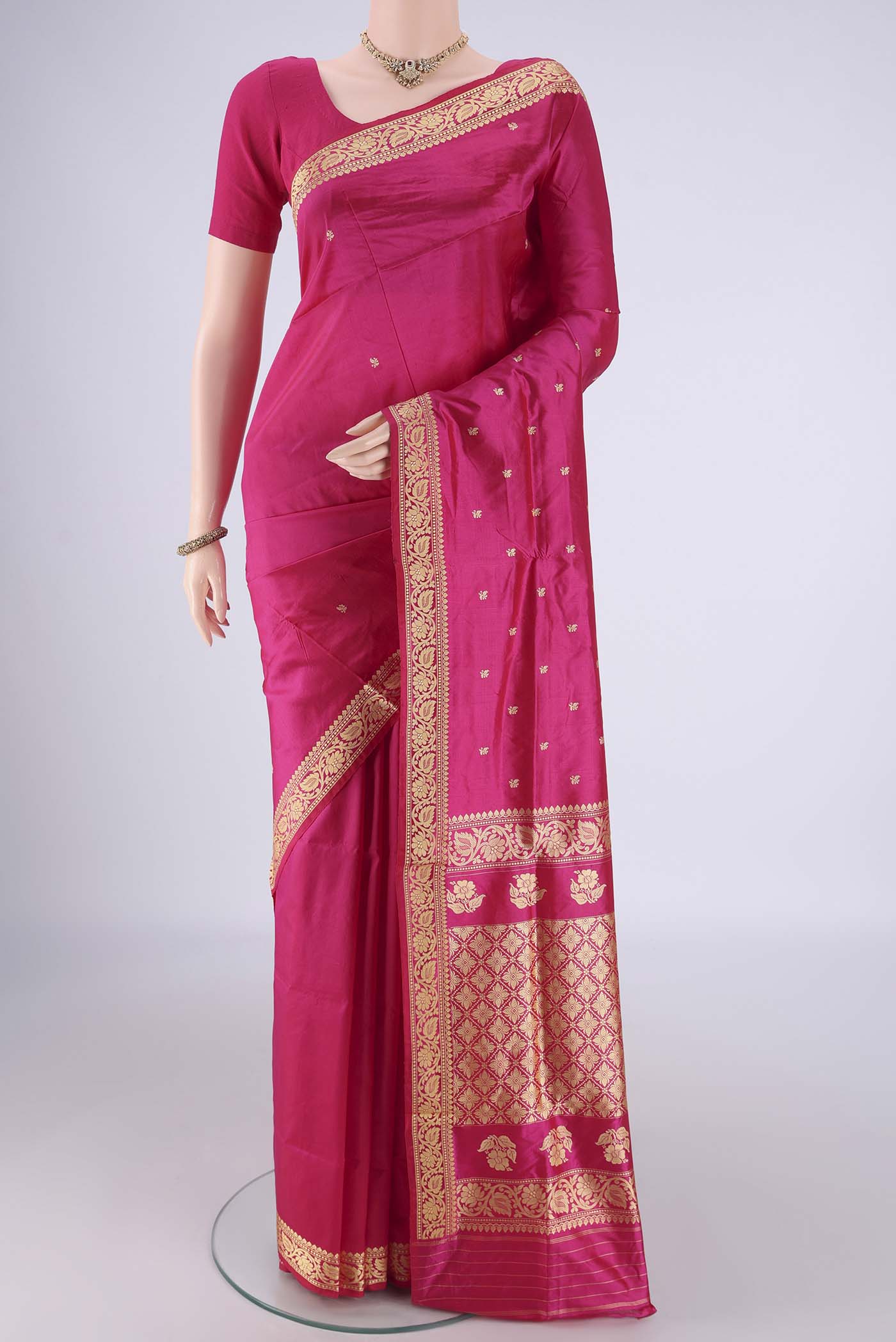 Rani Pink Banarasi Katan Silk Saree with Thread Butta on the body and Thread Border.  displayed on a mannequin