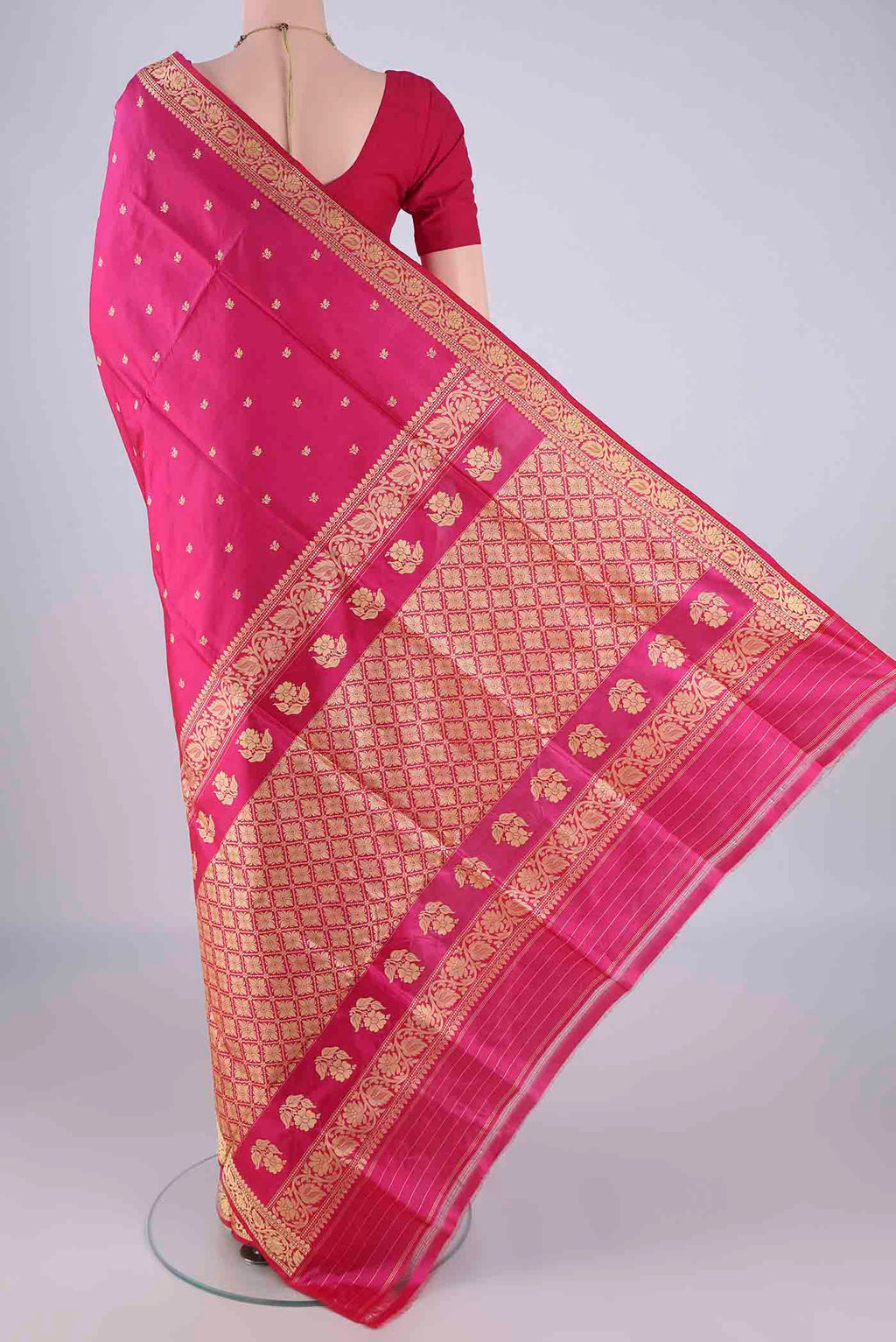 Flat view of Rani Pink Banarasi Katan Silk Saree with Thread Butta on the body and Thread Border. 