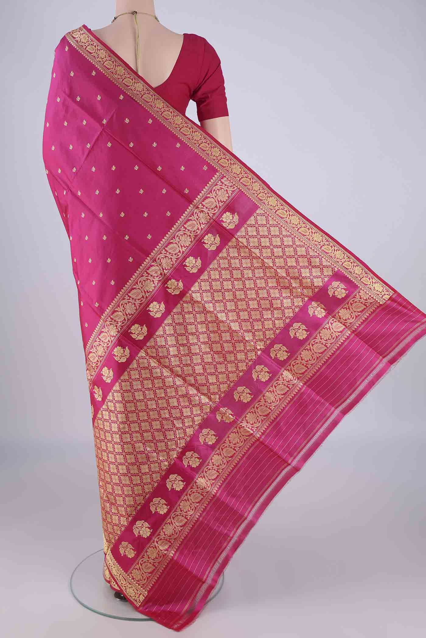 Flat view of Rani Pink Banarasi Katan Silk Saree with Thread Butta on the body and Thread Border. 