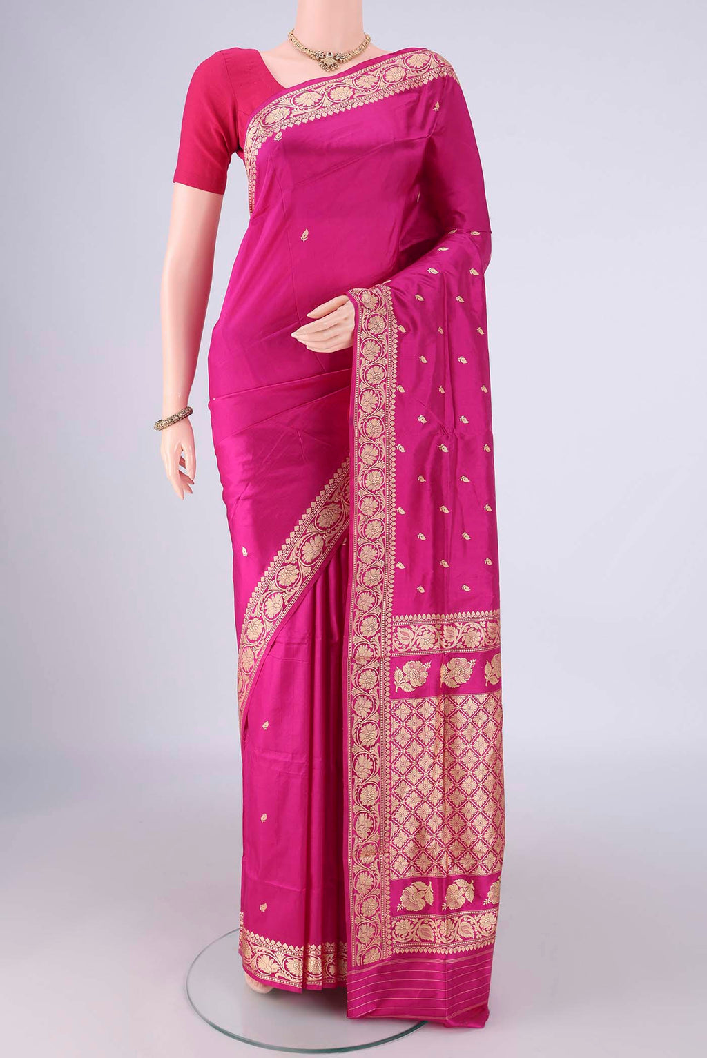 Rani Pink Banarasi Silk Saree with Thread Butta on the body and Thread Border.  displayed on a mannequin