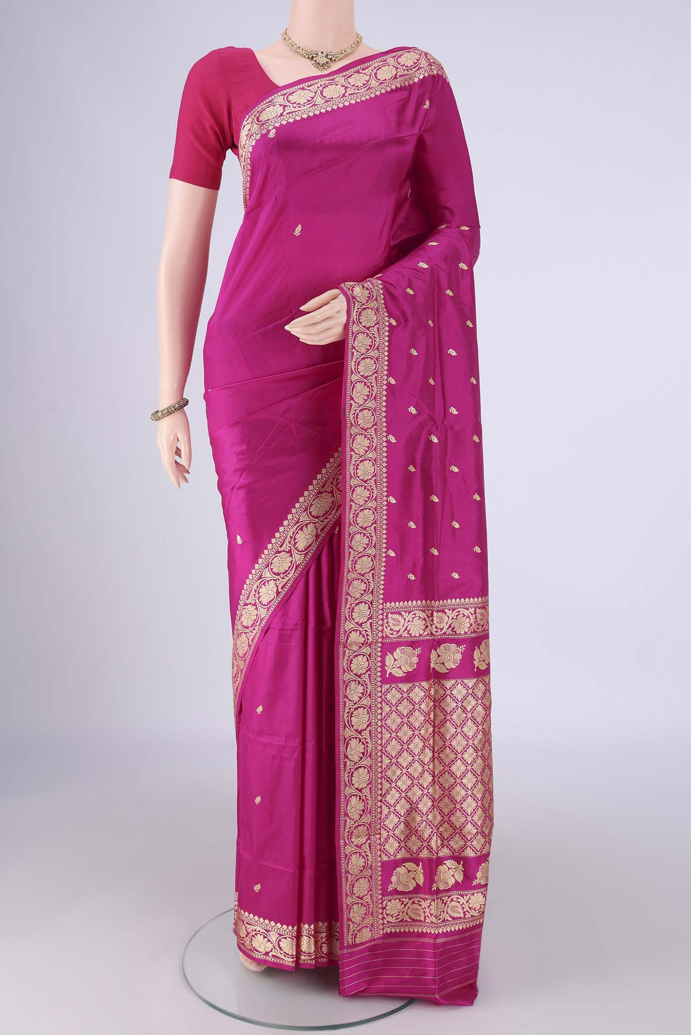 Rani Pink Banarasi Silk Saree with Thread Butta on the body and Thread Border.  displayed on a mannequin