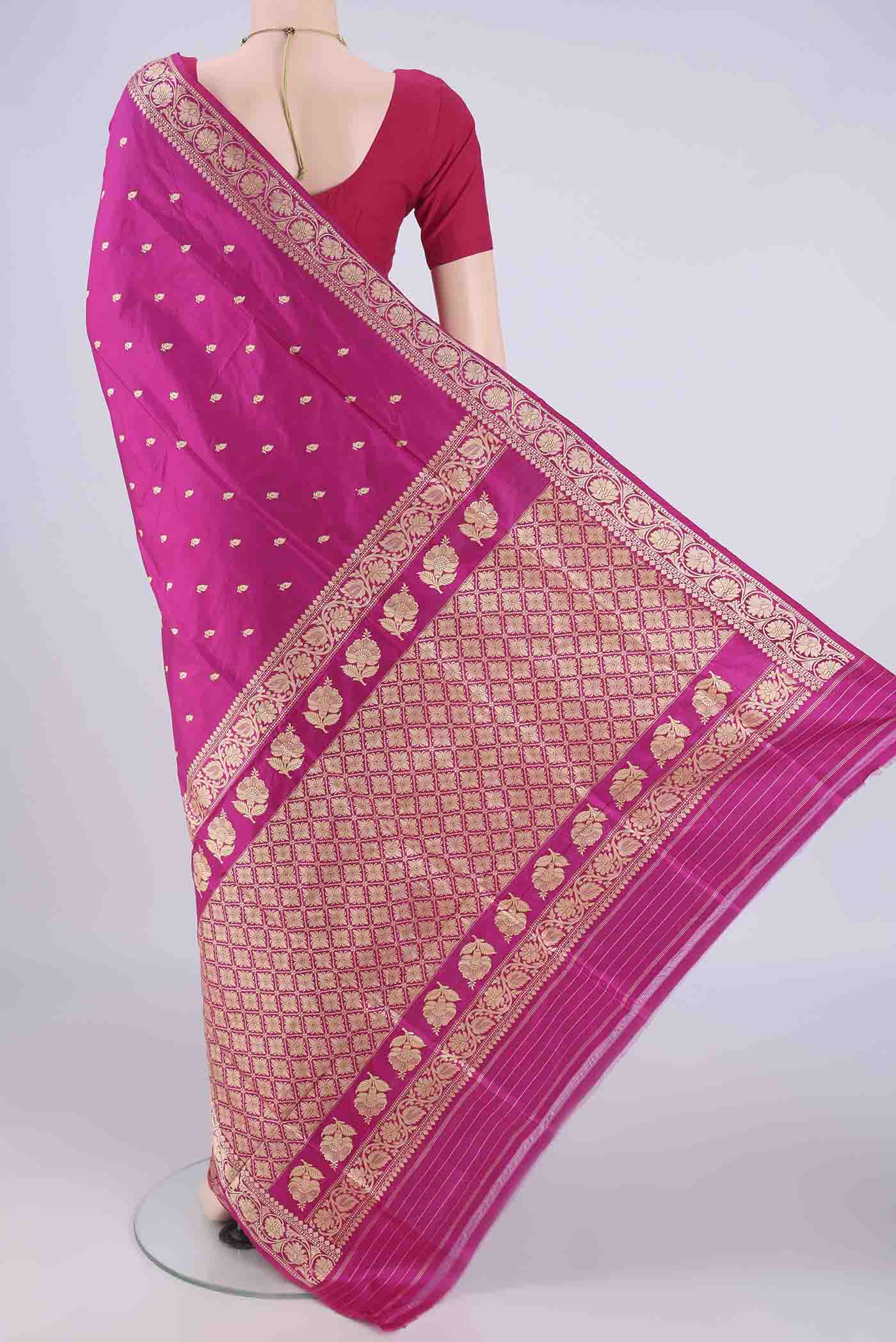 Flat view of Rani Pink Banarasi Silk Saree with Thread Butta on the body and Thread Border. 