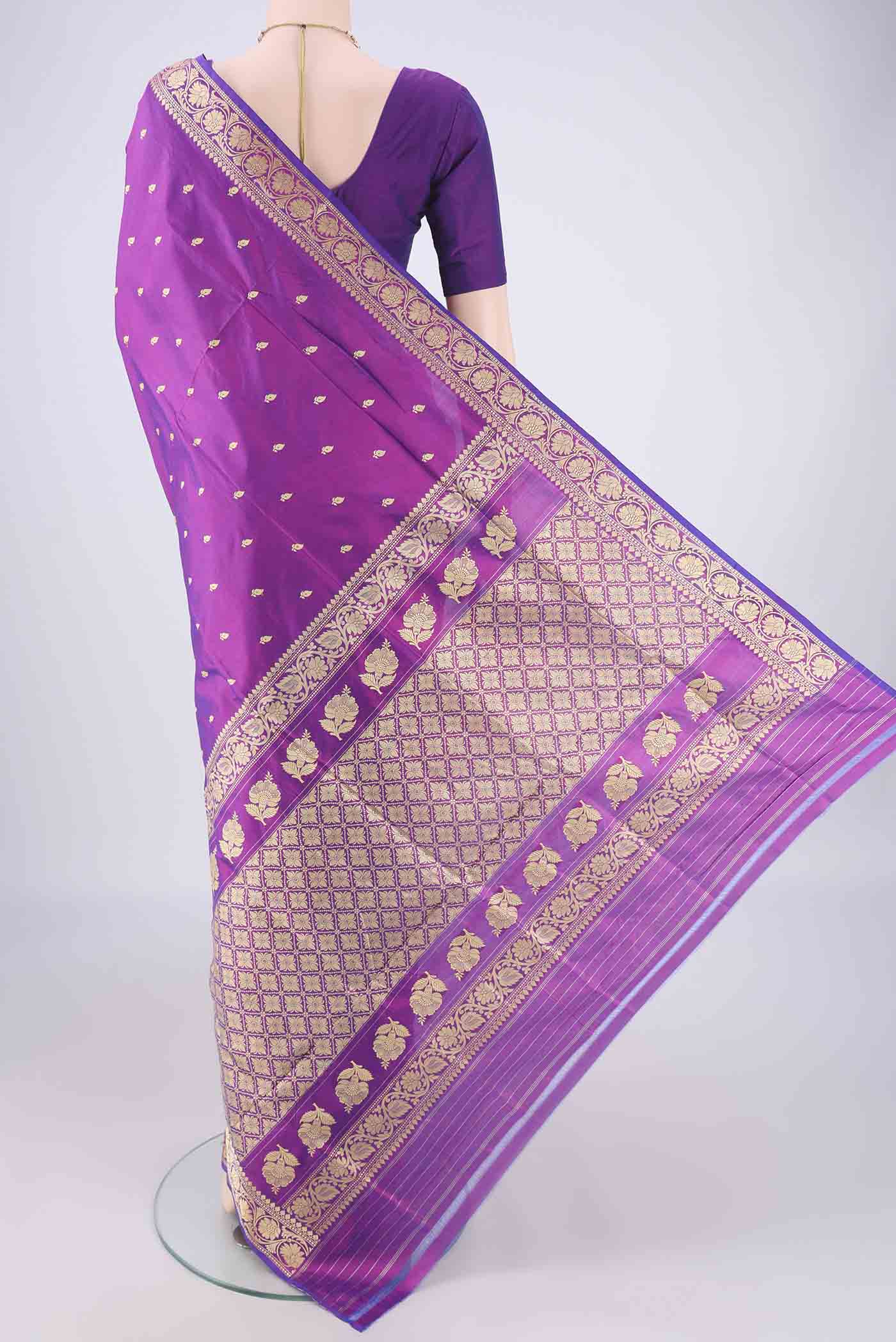 Flat view of Magenta Banarasi Katan Silk Saree with Thread Butta on the body and Thread Border. 