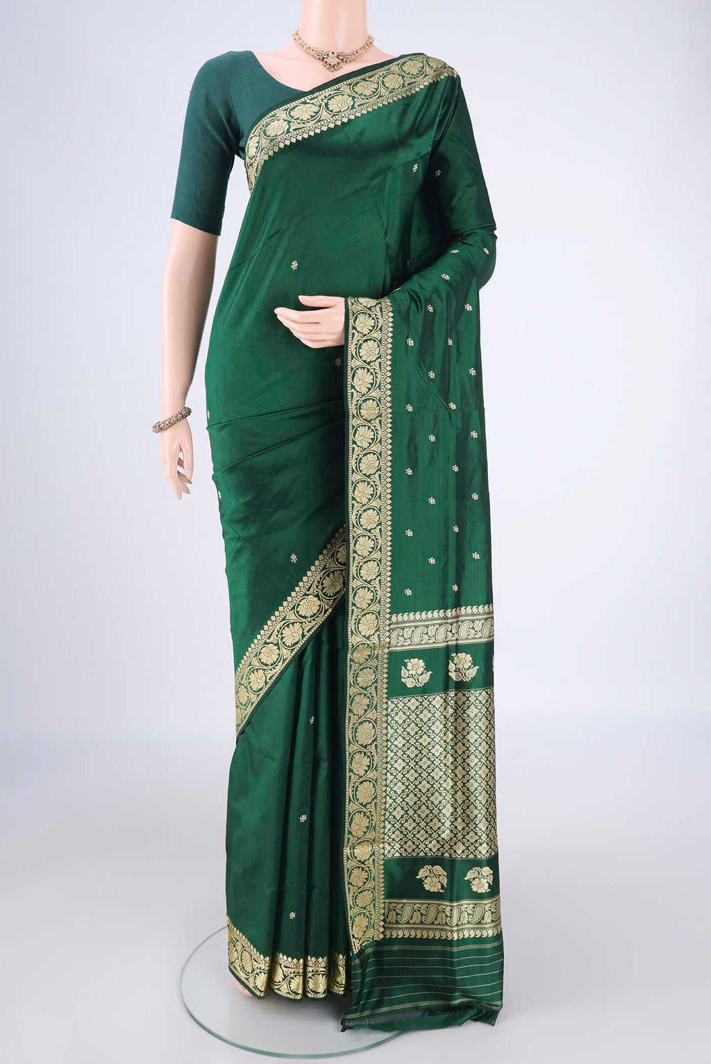 Bottle Green Banarasi Katan Silk Saree with Thread Butta on the body and Thread Border.  displayed on a mannequin