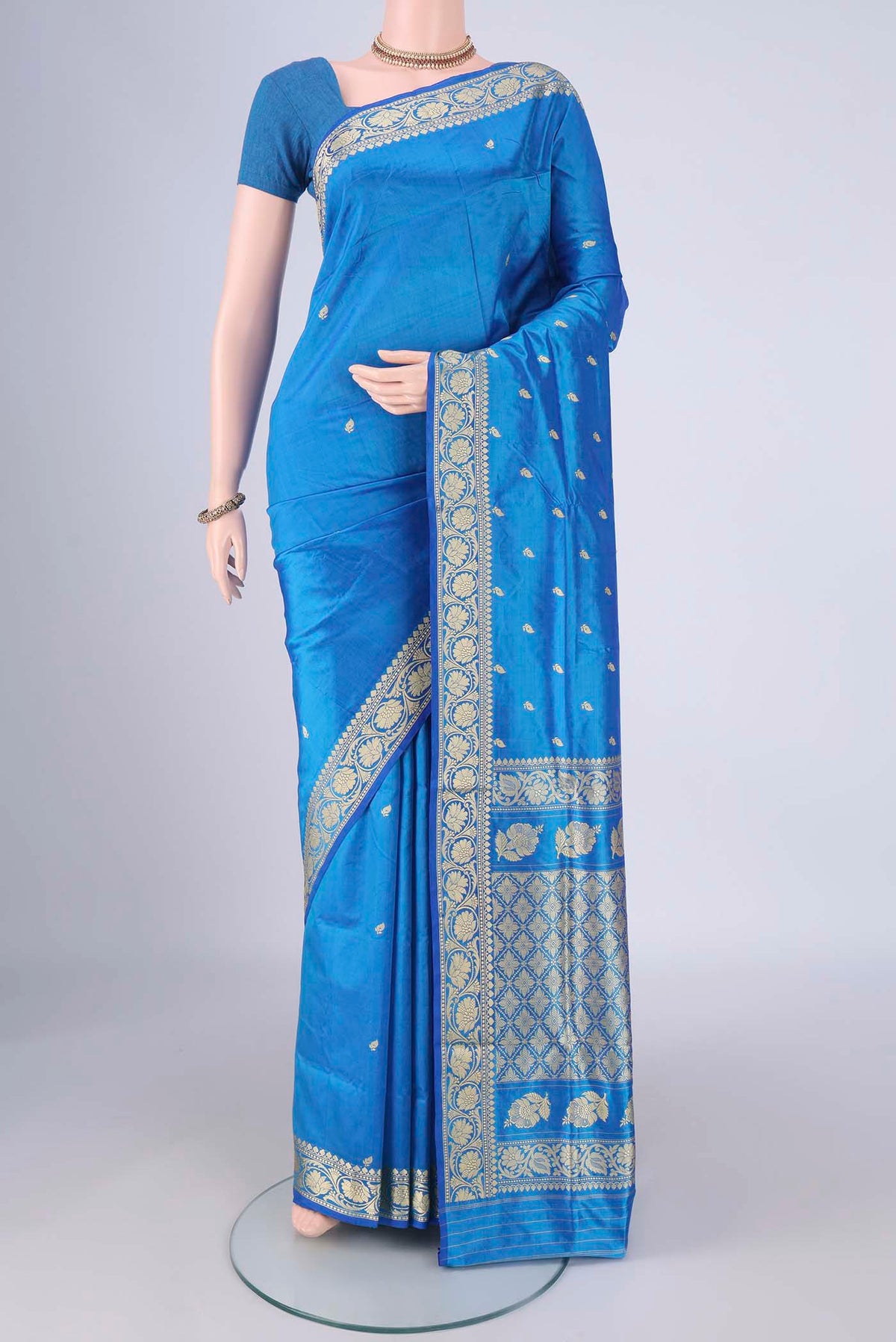 Blue Banarasi Katan Silk Saree with Thread Butta on the body and Thread Border.  displayed on a mannequin