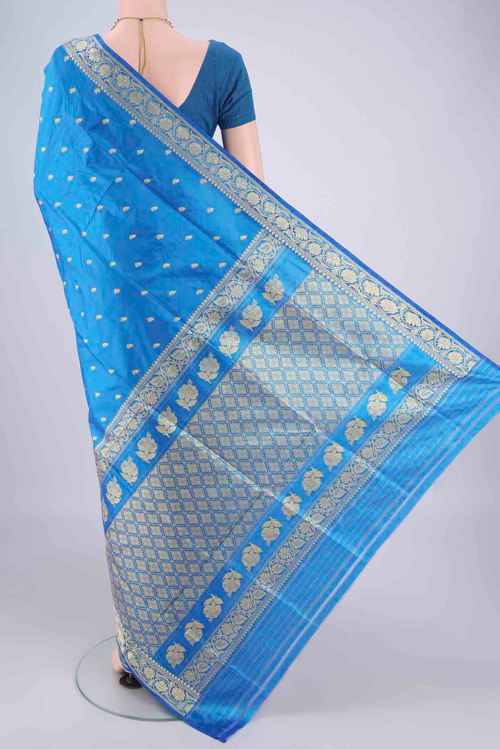 Flat view of Blue Banarasi Katan Silk Saree with Thread Butta on the body and Thread Border. 