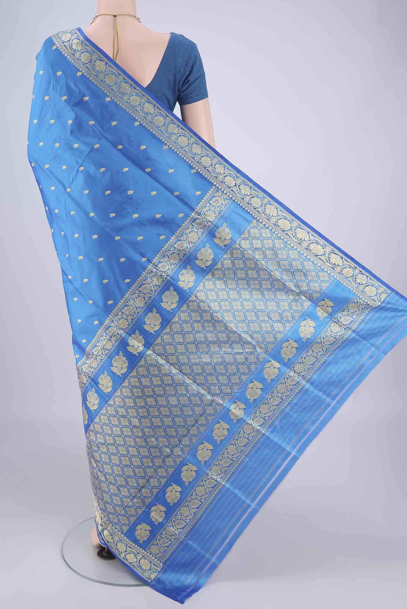 Flat view of Blue Banarasi Katan Silk Saree with Thread Butta on the body and Thread Border. 