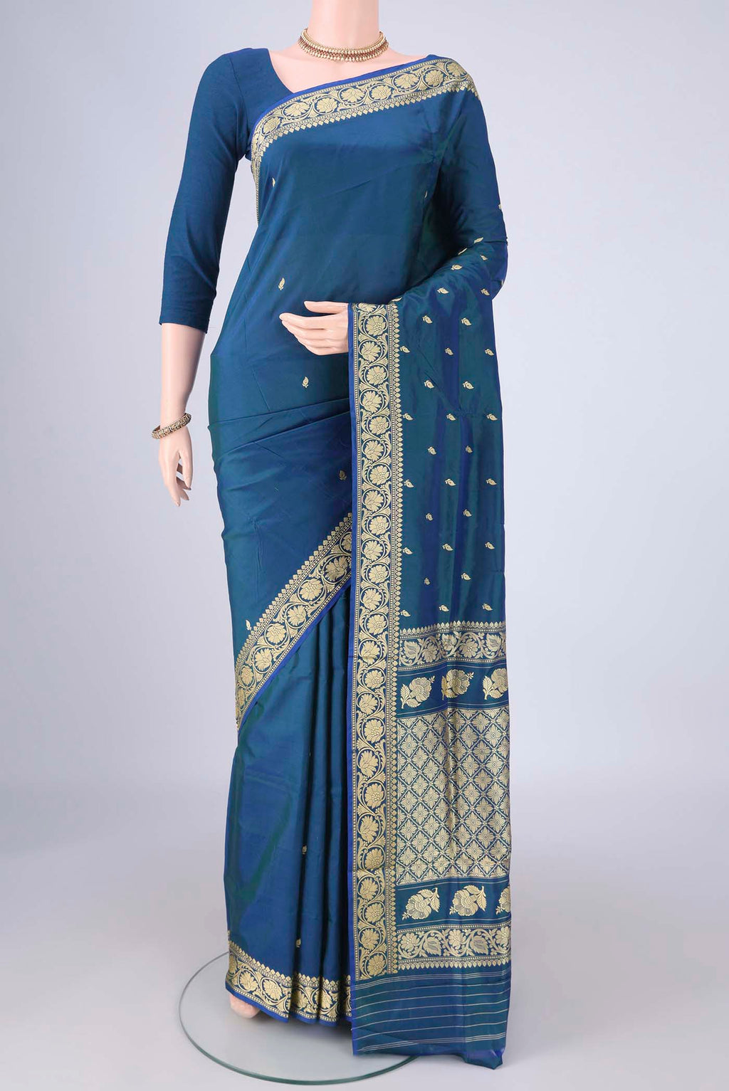Peacock Blue Dual Tone Banarasi Katan Silk Saree with Thread Butta on the body and Thread Border.  displayed on a mannequin