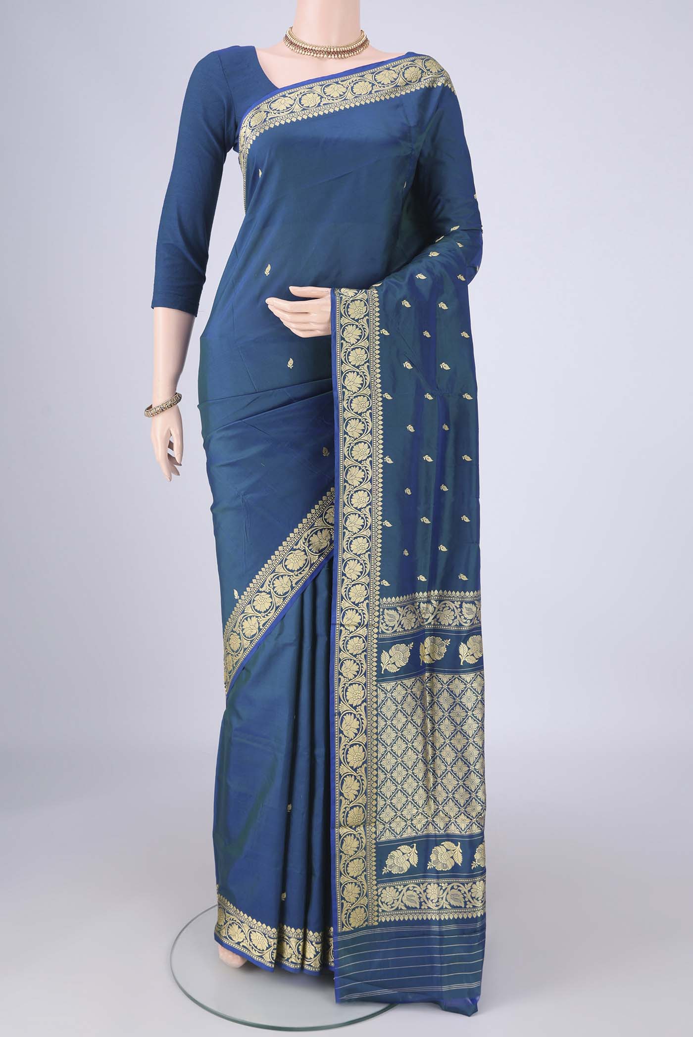 Peacock Blue Dual Tone Banarasi Katan Silk Saree with Thread Butta on the body and Thread Border.  displayed on a mannequin