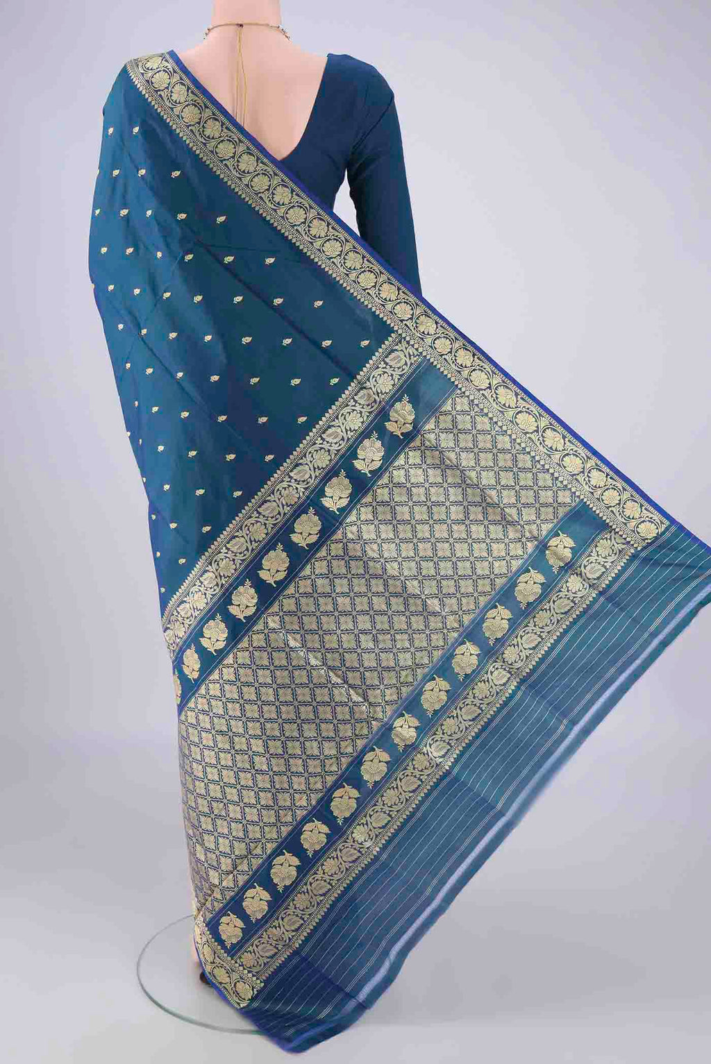 Flat view of Peacock Blue Dual Tone Banarasi Katan Silk Saree with Thread Butta on the body and Thread Border. 