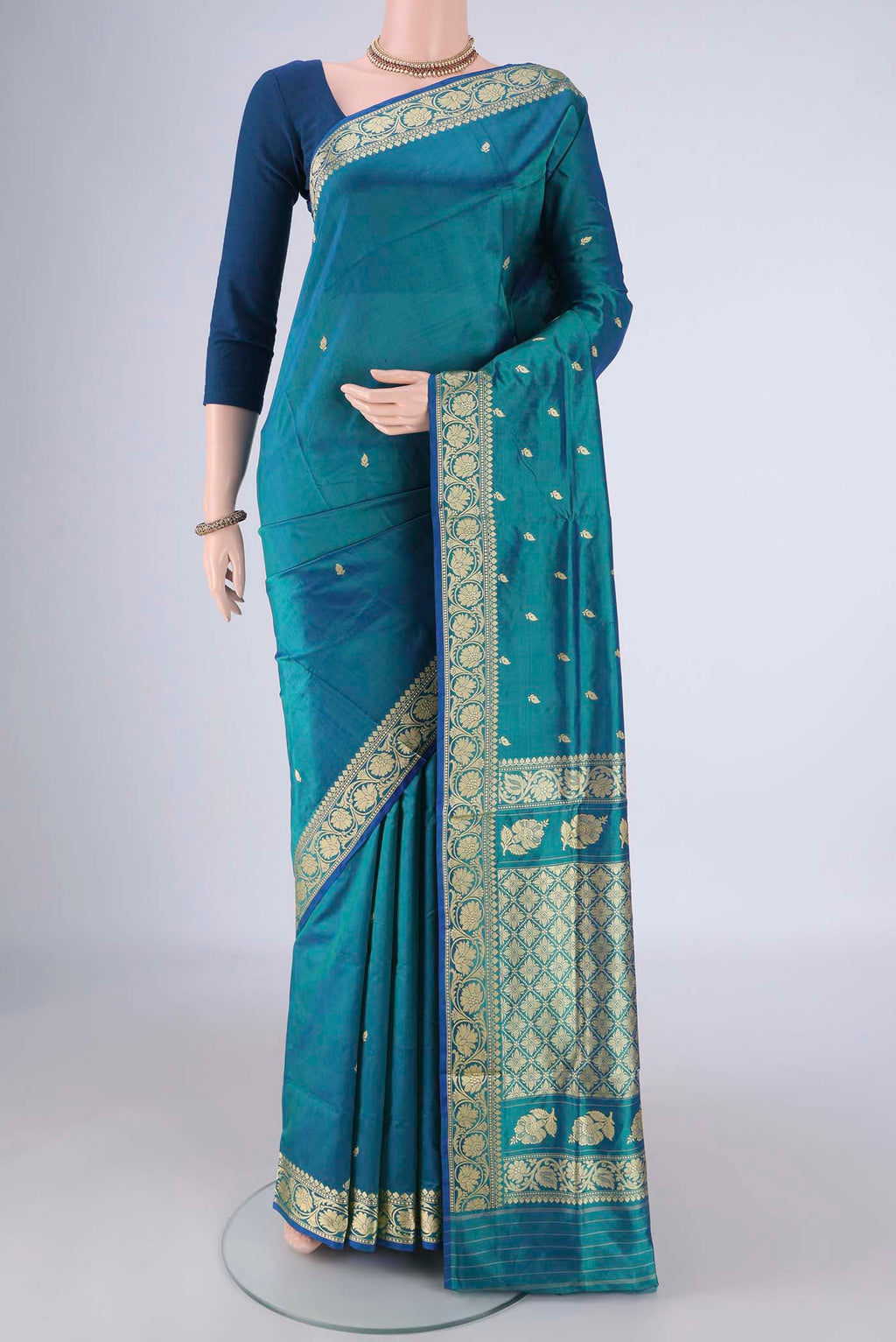 Peacock Blue Banarasi Katan Silk Saree with Thread Butta on the body and Thread Border.  displayed on a mannequin