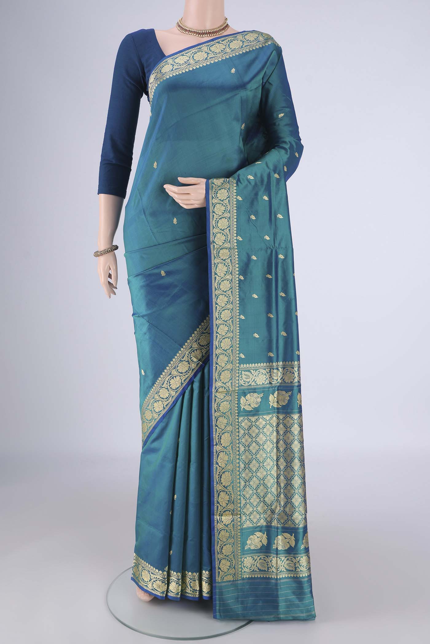 Peacock Blue Banarasi Katan Silk Saree with Thread Butta on the body and Thread Border.  displayed on a mannequin