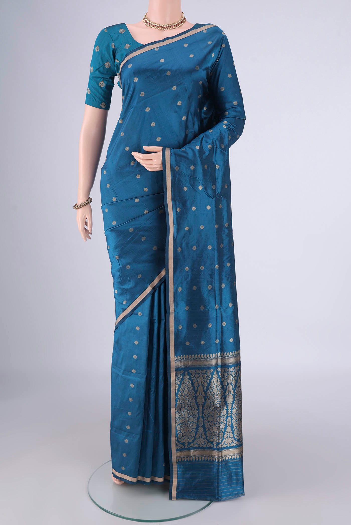 Blue Banarasi Silk Saree with Zari Butta on the body and Thin Zari Line.  displayed on a mannequin
