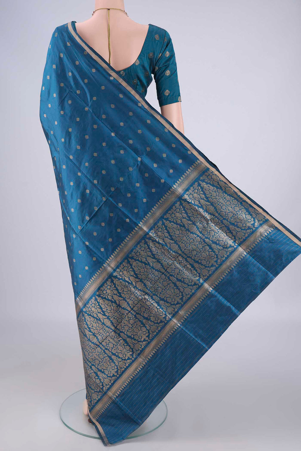 Flat view of Blue Banarasi Silk Saree with Zari Butta on the body and Thin Zari Line. 