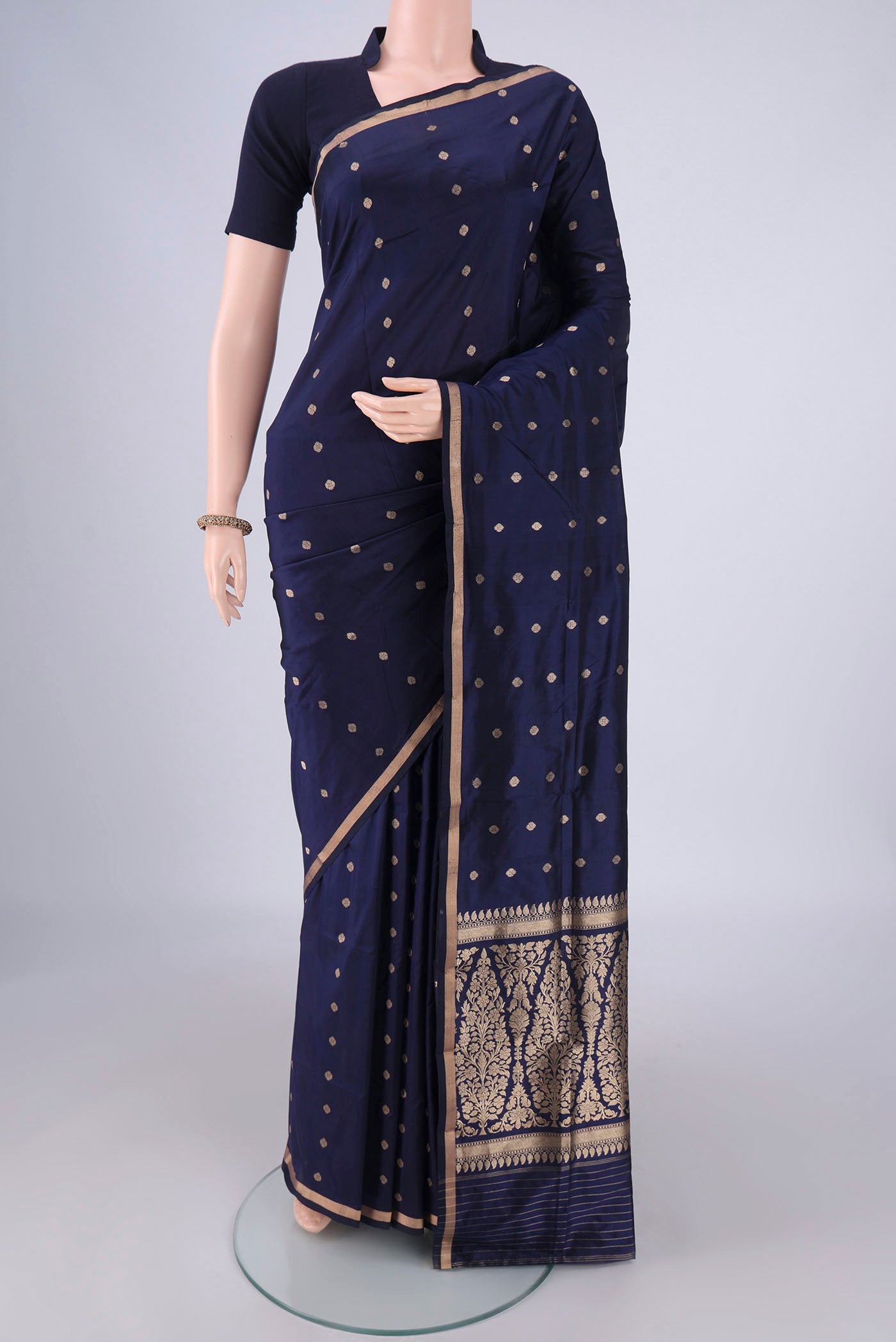 Navy Blue Banarasi Silk Saree with Zari Butta on the body and Thin Zari Line.  displayed on a mannequin