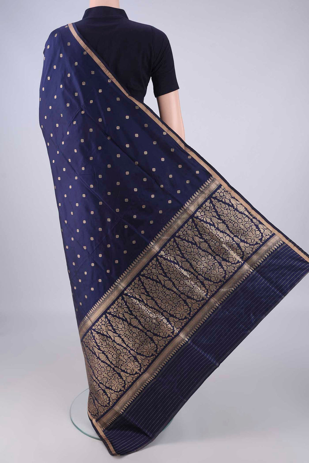 Flat view of Navy Blue Banarasi Silk Saree with Zari Butta on the body and Thin Zari Line. 