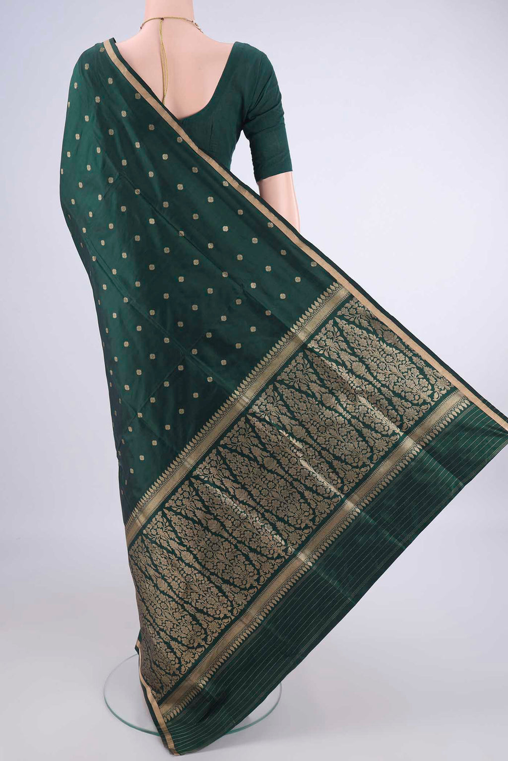 Flat view of Bottle Green Banarasi Katan Silk Saree with Zari Butta on the body and Zari Border. 