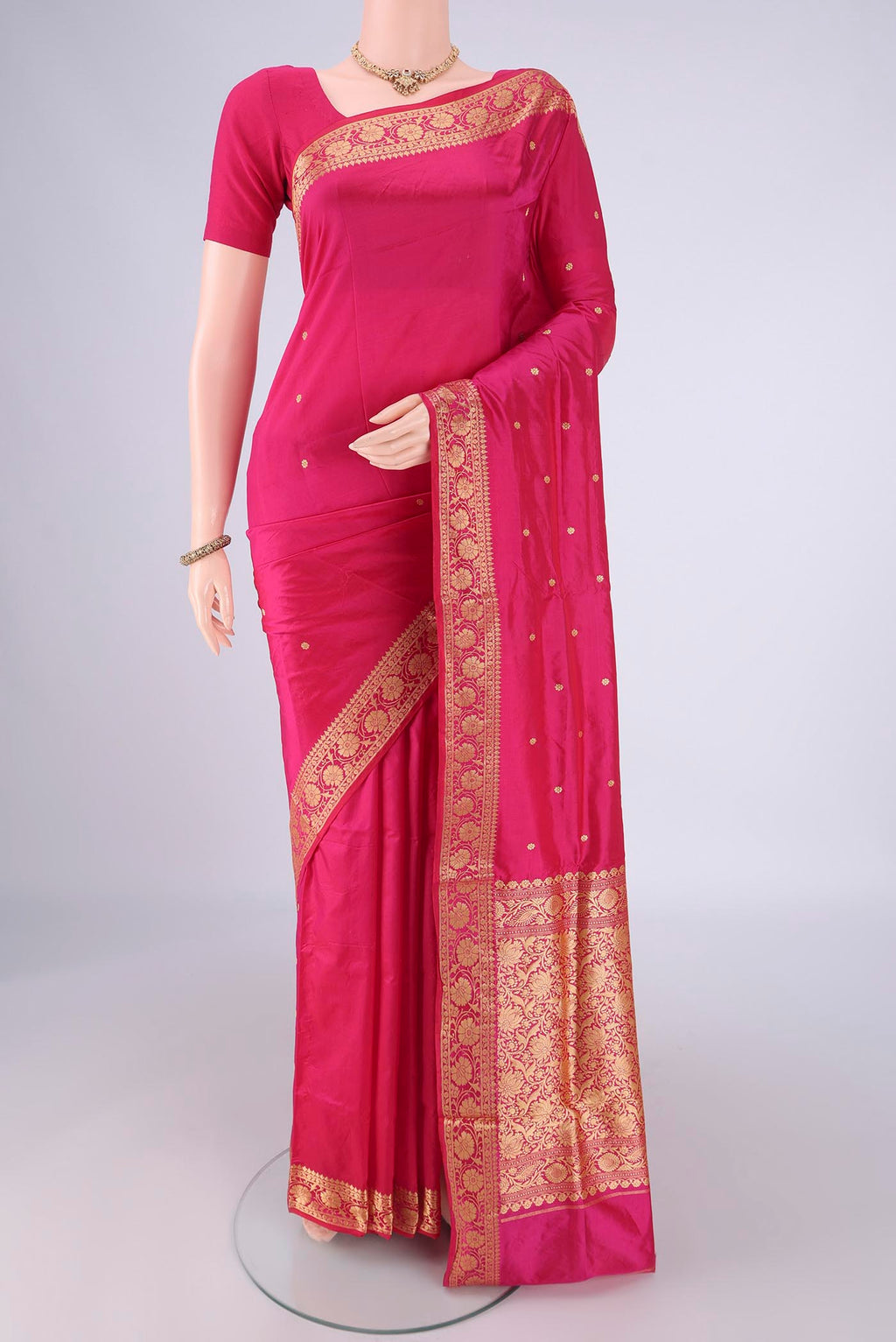 Rani Pink Banarasi Silk Saree with Thread Butta on the body and Thread Border.  displayed on a mannequin