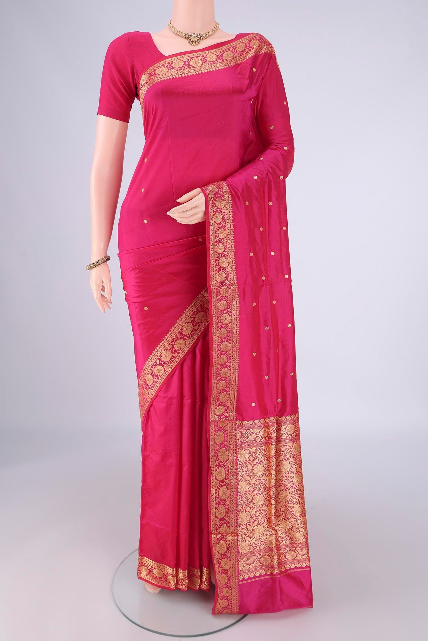 Rani Pink Banarasi Silk Saree with Thread Butta on the body and Thread Border.  displayed on a mannequin